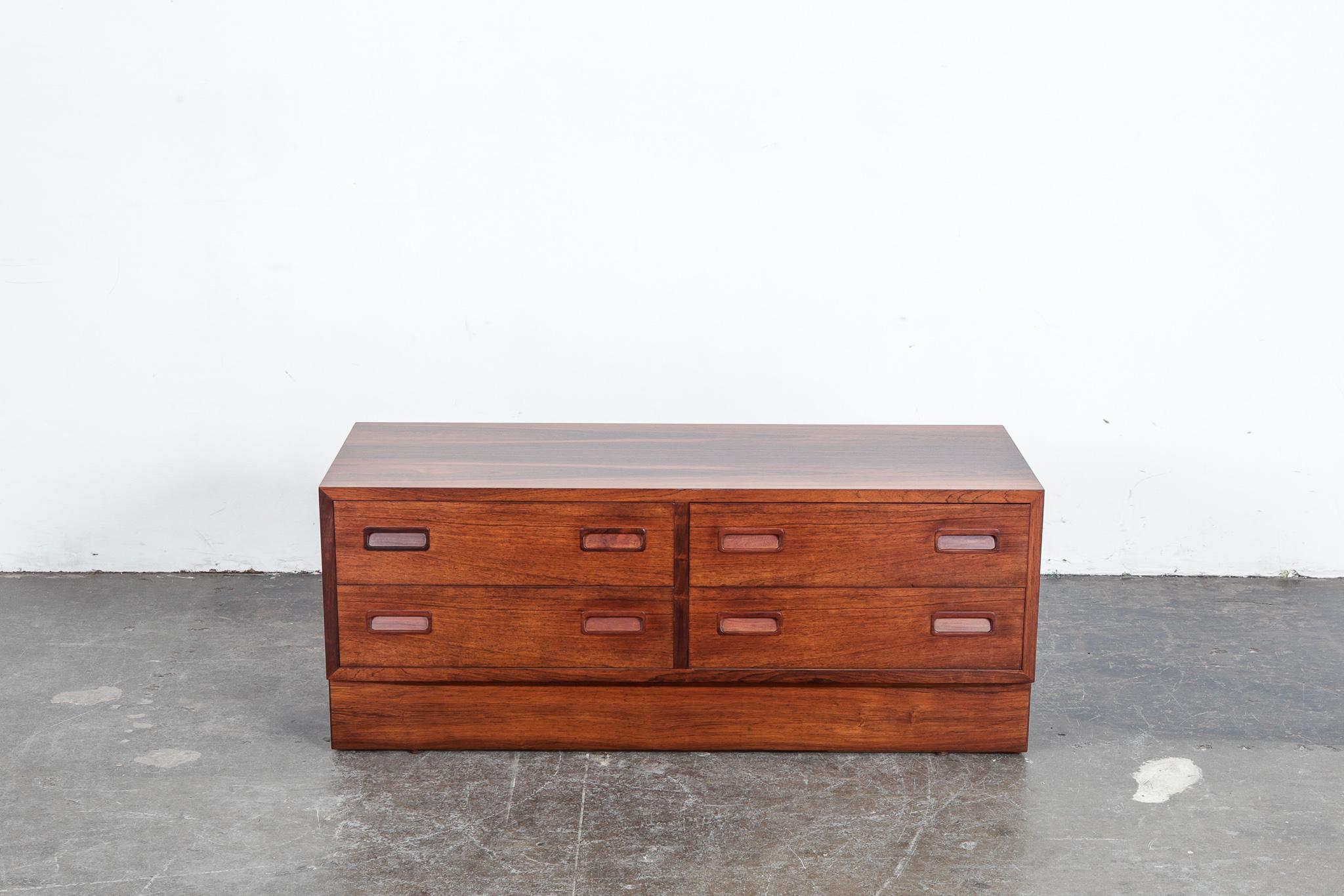 Danish Mid-Century Modern 4-drawer rosewood console designed by Poul Hundevad, 1960s. Newly refinished in lacquer with beautiful strong grain throughout. Danish furniture makers symbol on side of drawer.