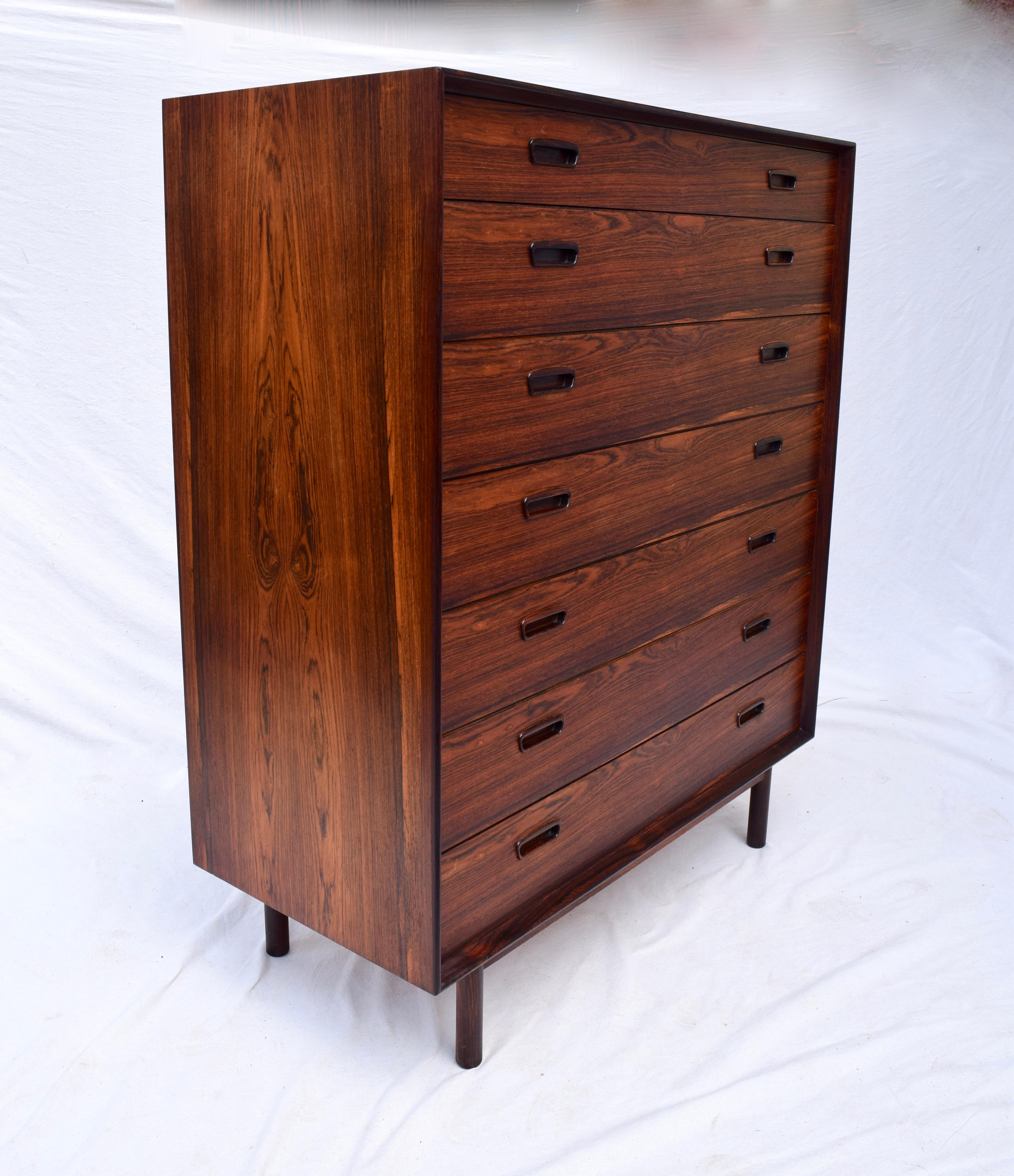 Rosewood chest of seven drawers attributed to Poul Hundevad. An unusually striking piece of generous dimensions in terms of Danish upright styles, having Insert handles and finished on all four sides. Solid wood construction. Very much in the manner