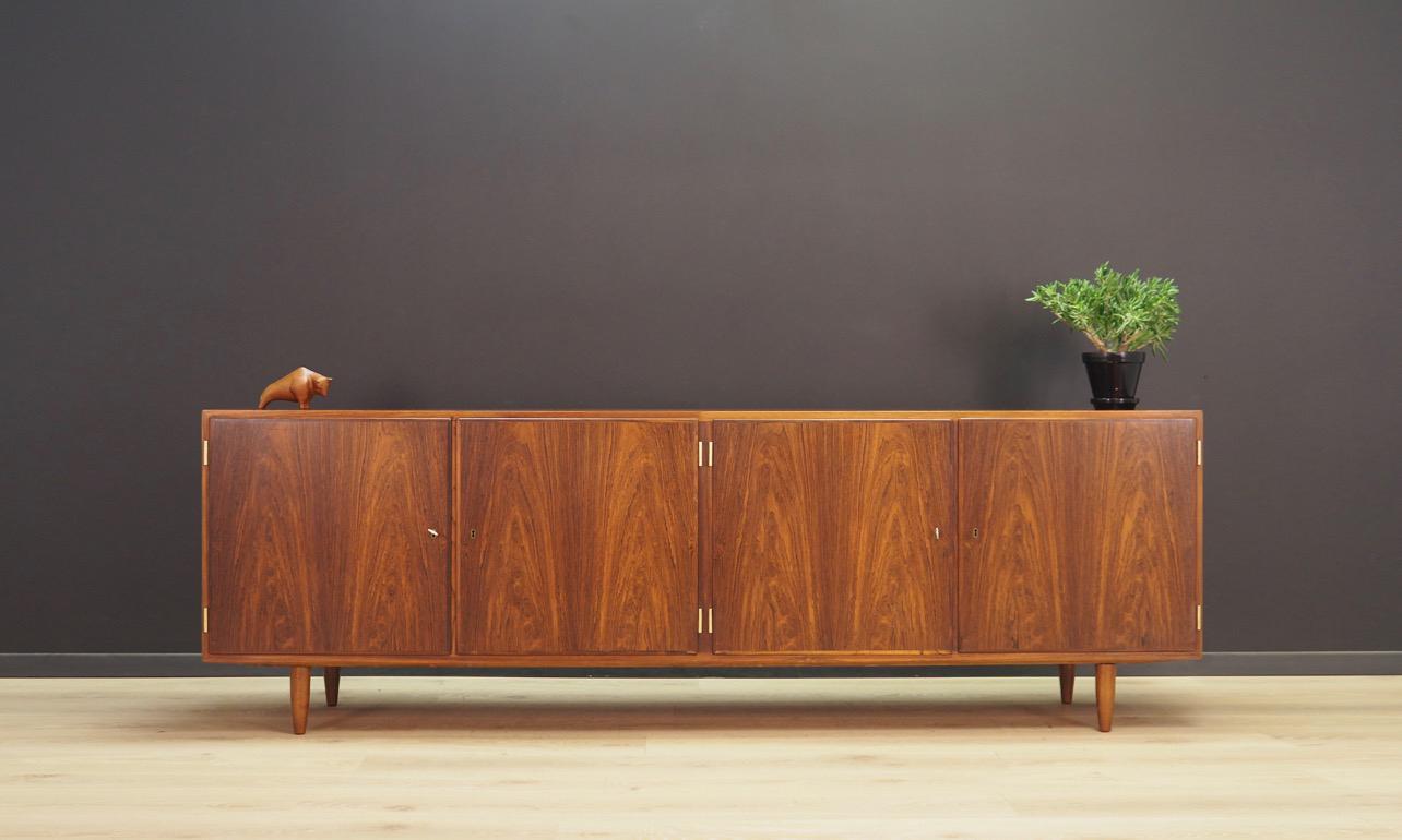 Extraordinary sideboard, Danish minimalism from the 1960s-1970s, designed by the leading Danish designer Poul Hundevad. A Classic form with opening doors, practical drawers and shelves inside. Sideboard veneered with rosewood. The key in the set.