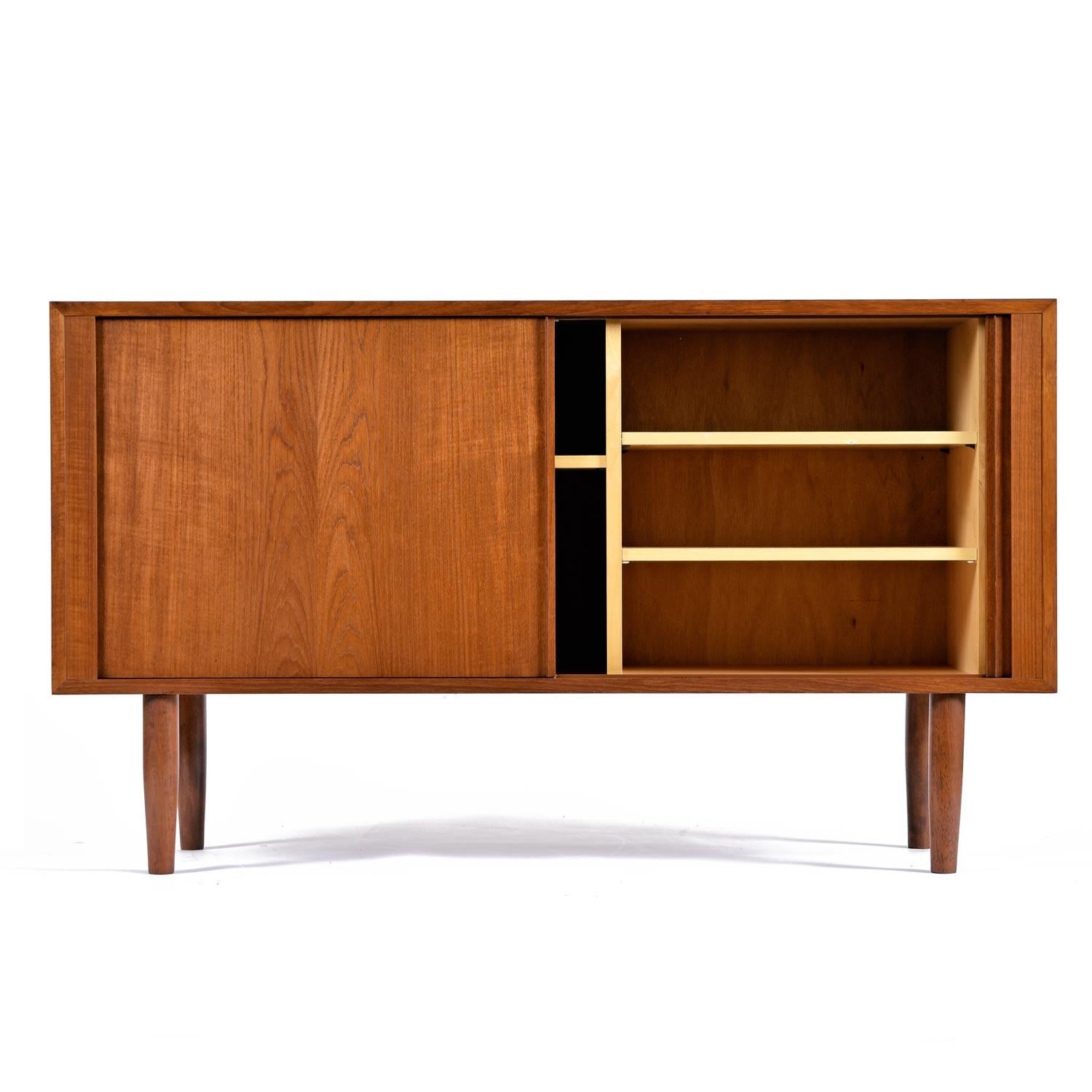 Mid-Century Modern teak credenza by Poul Hundevad. This handsome piece celebrates the elegant minimalist form of the period. Bearing the makers mark on the back left corner and 
