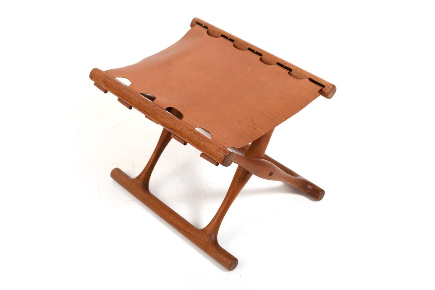 Guldhøj folding stool by Poul Hundevad. Model PH-41. Made in teak. Later new brown vintage leather cover.Produced by Poul Hundevad Vamdrup Denmark 1960s.
