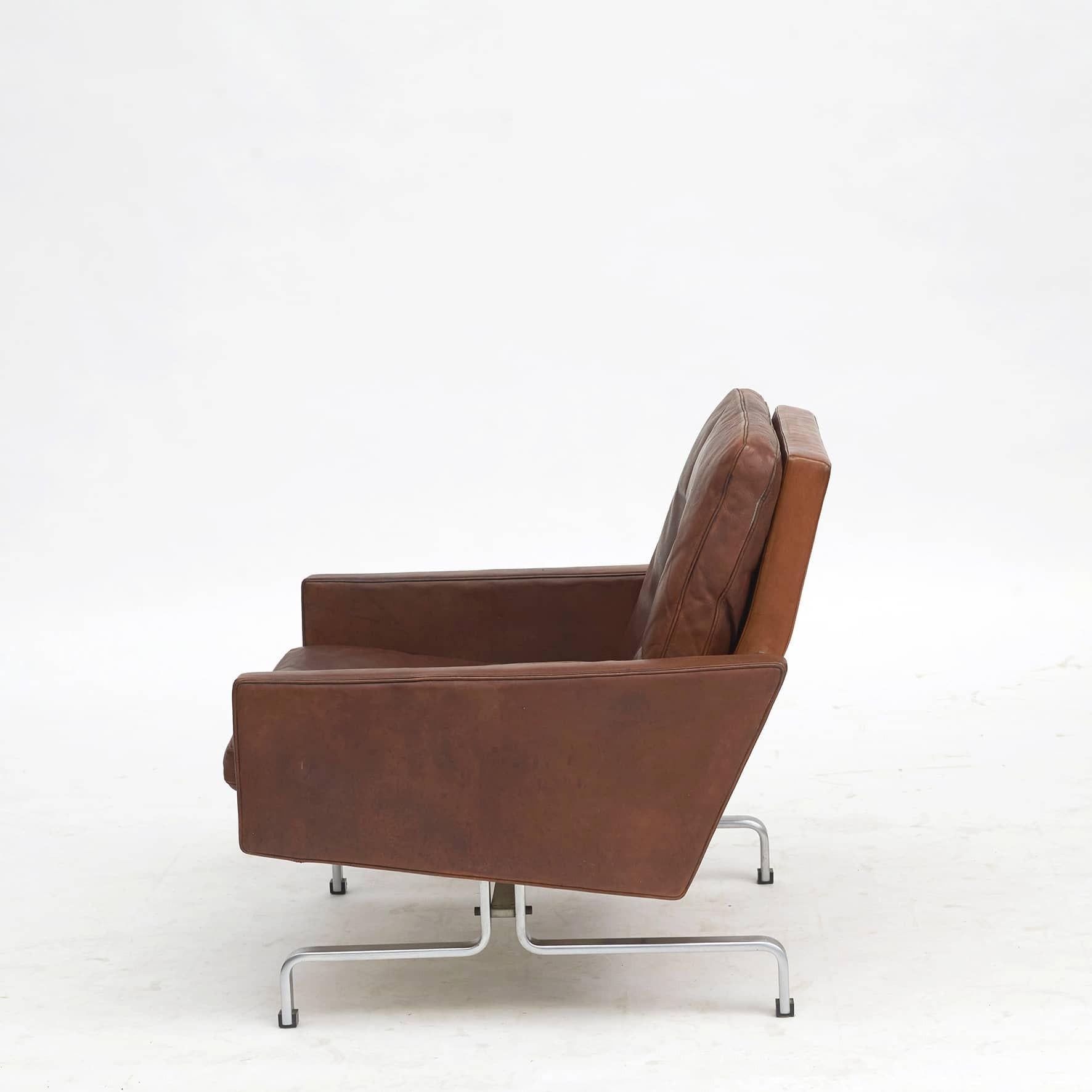 Poul Kjærholm easy chair Model PK-31.
Original cognac leather and matt chromed spring steel frame.
The frame is marked with the EKC Denmark logo.

Designed by Poul Kjærholm in 1958 and made by E. Kold Christensen in the 1960's.
 