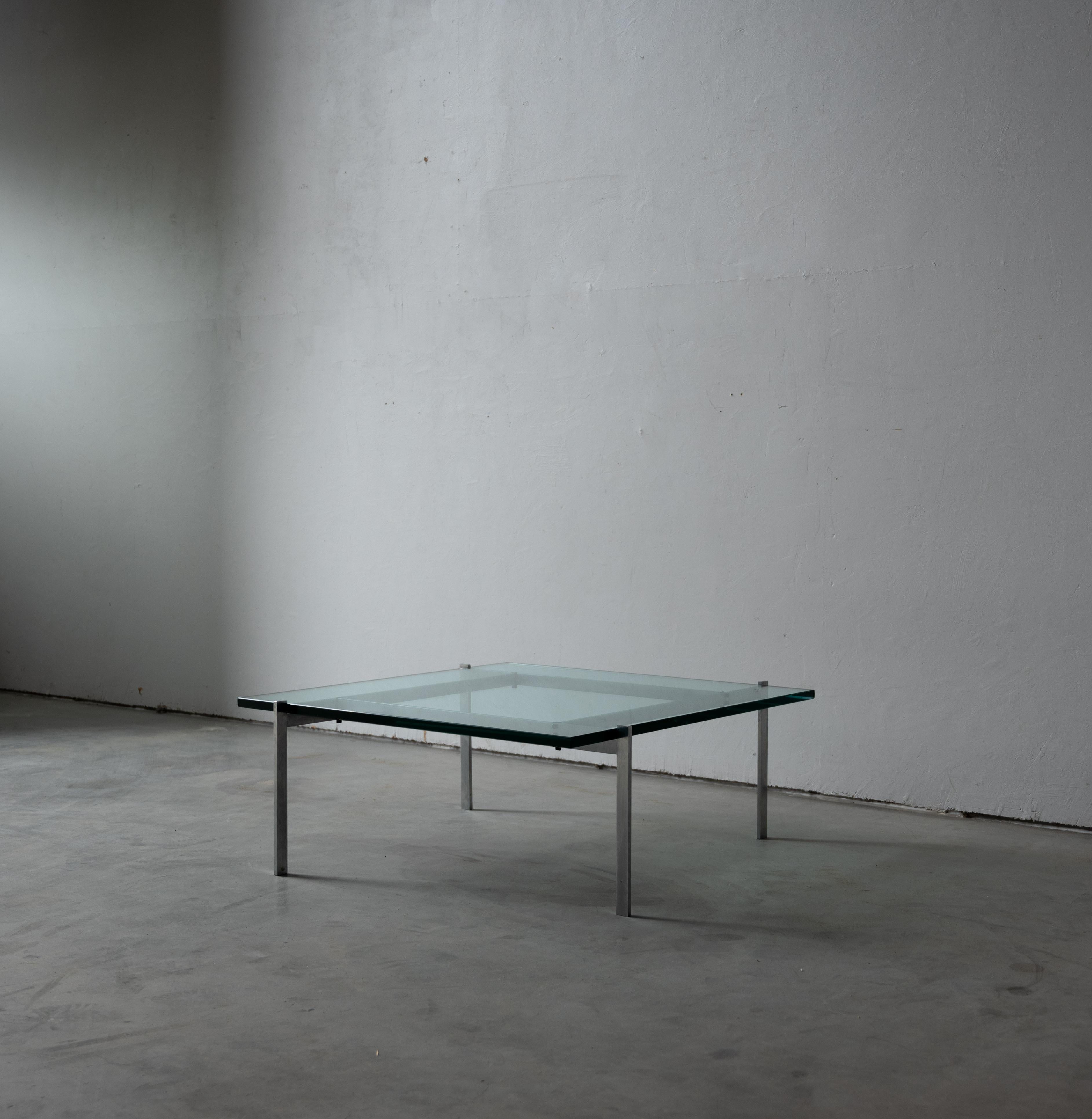 A glass and metal coffee table designed by Poul Kjærholm and produced by E. Kold Christensen, Denmark, c. 1960s. Stamped.


