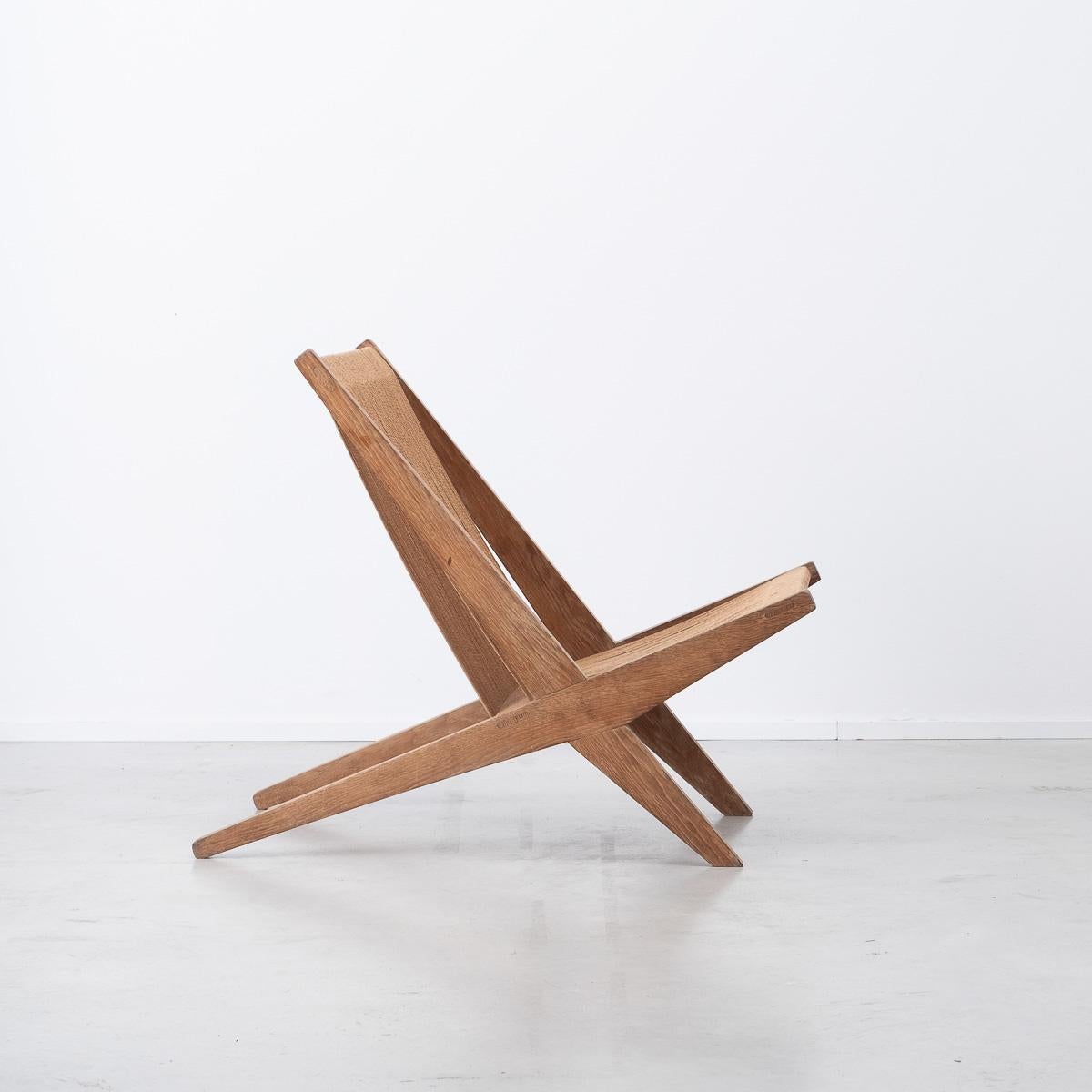 This sleek lounge chair is crafted from oak and bound by a rope seat and backrest. The angular frame cuts a modern profile, whilst the wood has aged nicely. Attributed to Poul Kjaerholm & Jørgen Høj for Thorald Madsen Snedkeri.

In very good