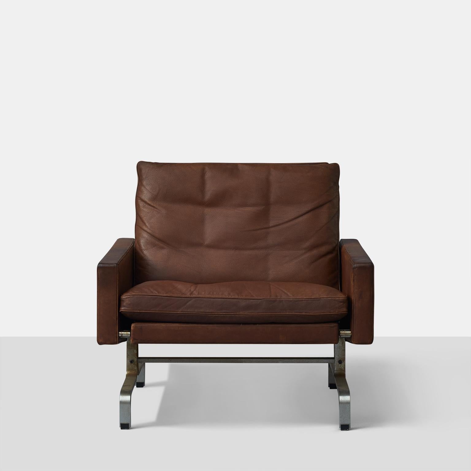 A PK 31/1 lounge chair by Poul Kjaerholm, produced by E. Kold Christensen. Features a matte- chromed steel base and original leather upholstery. Stamped signature. Leather and foam are soft and pliable. Some oxidation to frames, all original