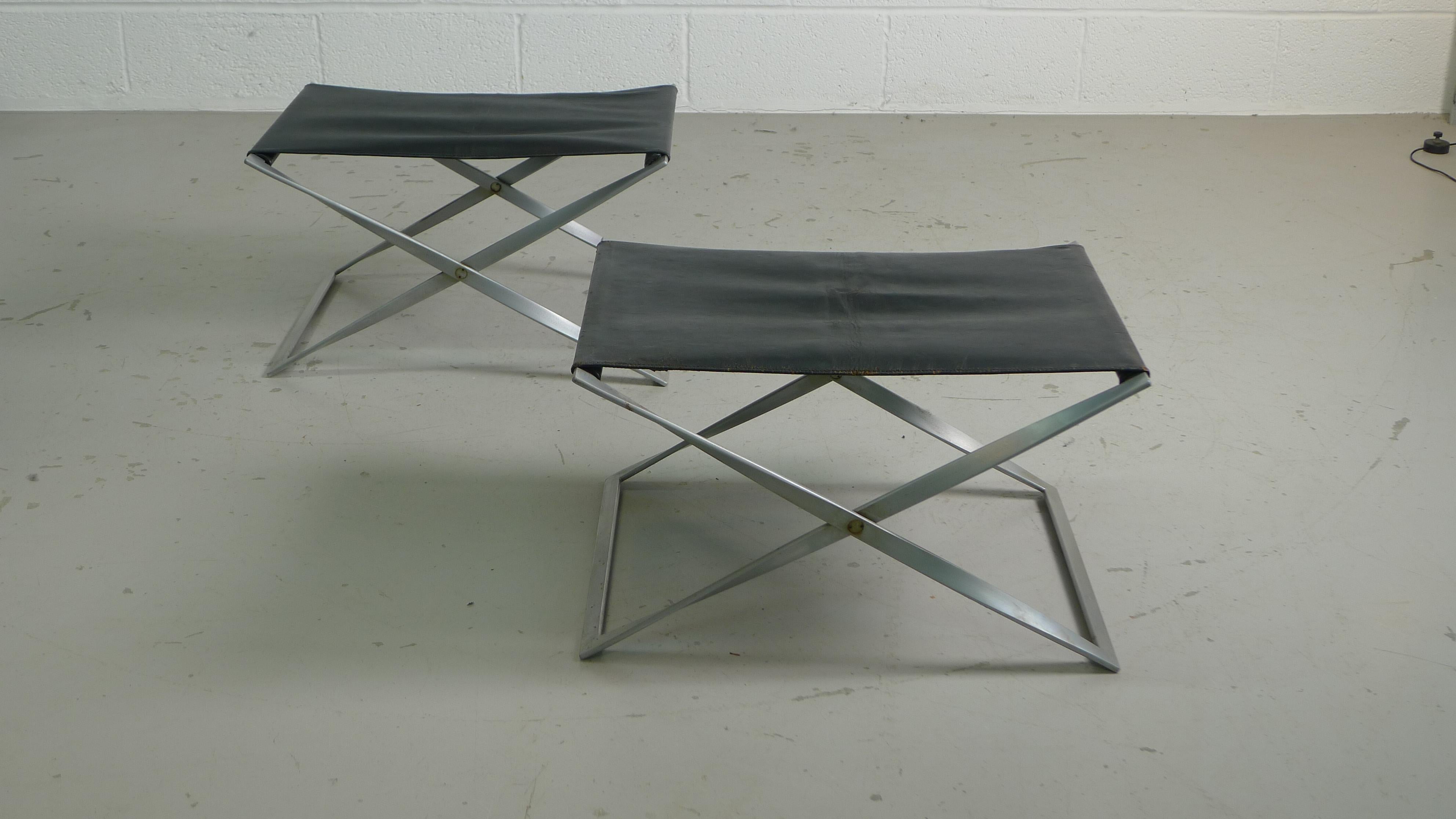 Poul Kjaerholm for E-Kold Christensen, Denmark, 1960s. PK-91 Folding Stools in chromed steel with the original black leather . Stool is stamped and displays the early stepped joints at the corners of the metal . 

Some minor pitting to metal