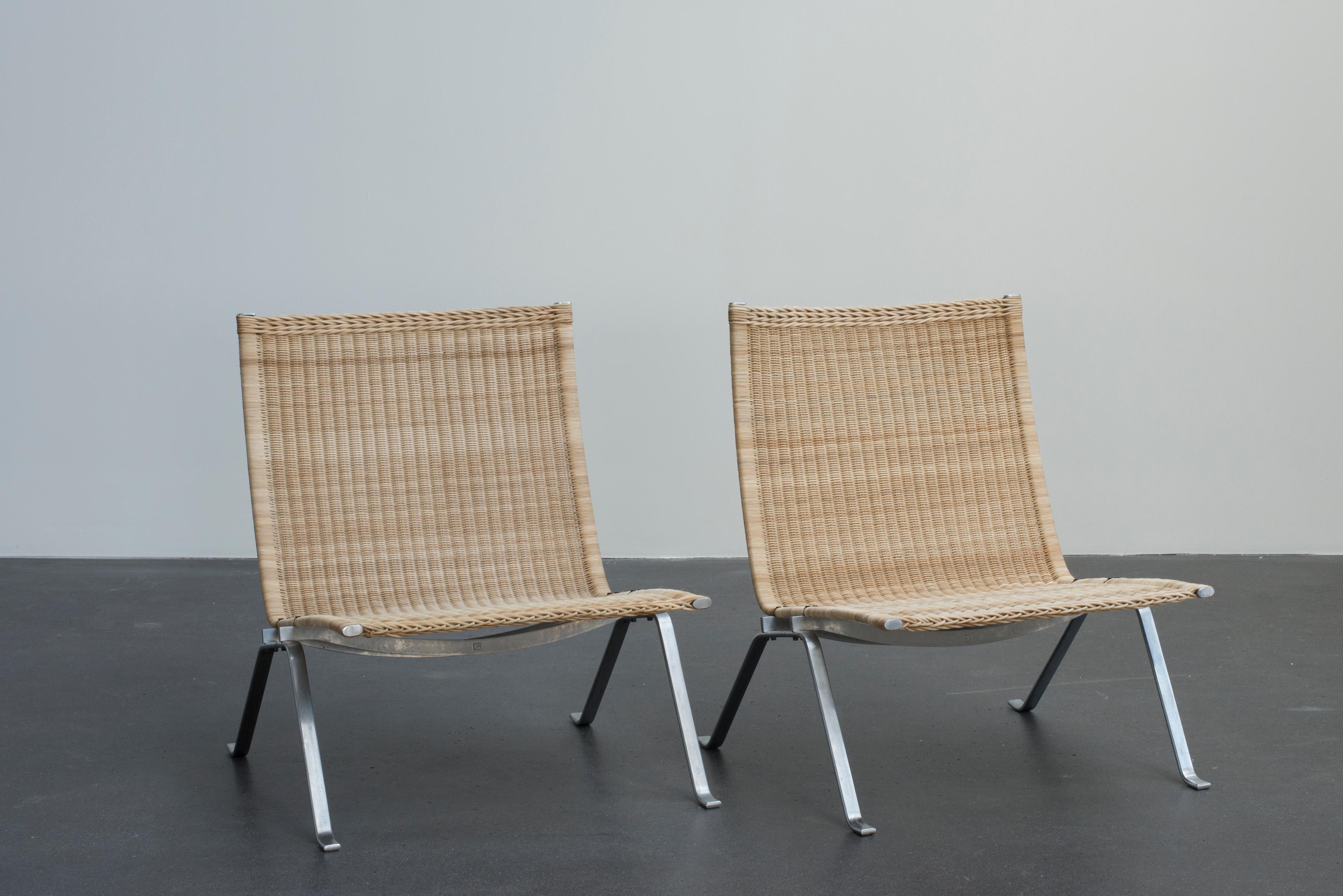 Poul Kjaerholm pair of PK22 easy chairs in dull chromium-plated steel and cane. Executed by E. Kold Christensen, Denmark.