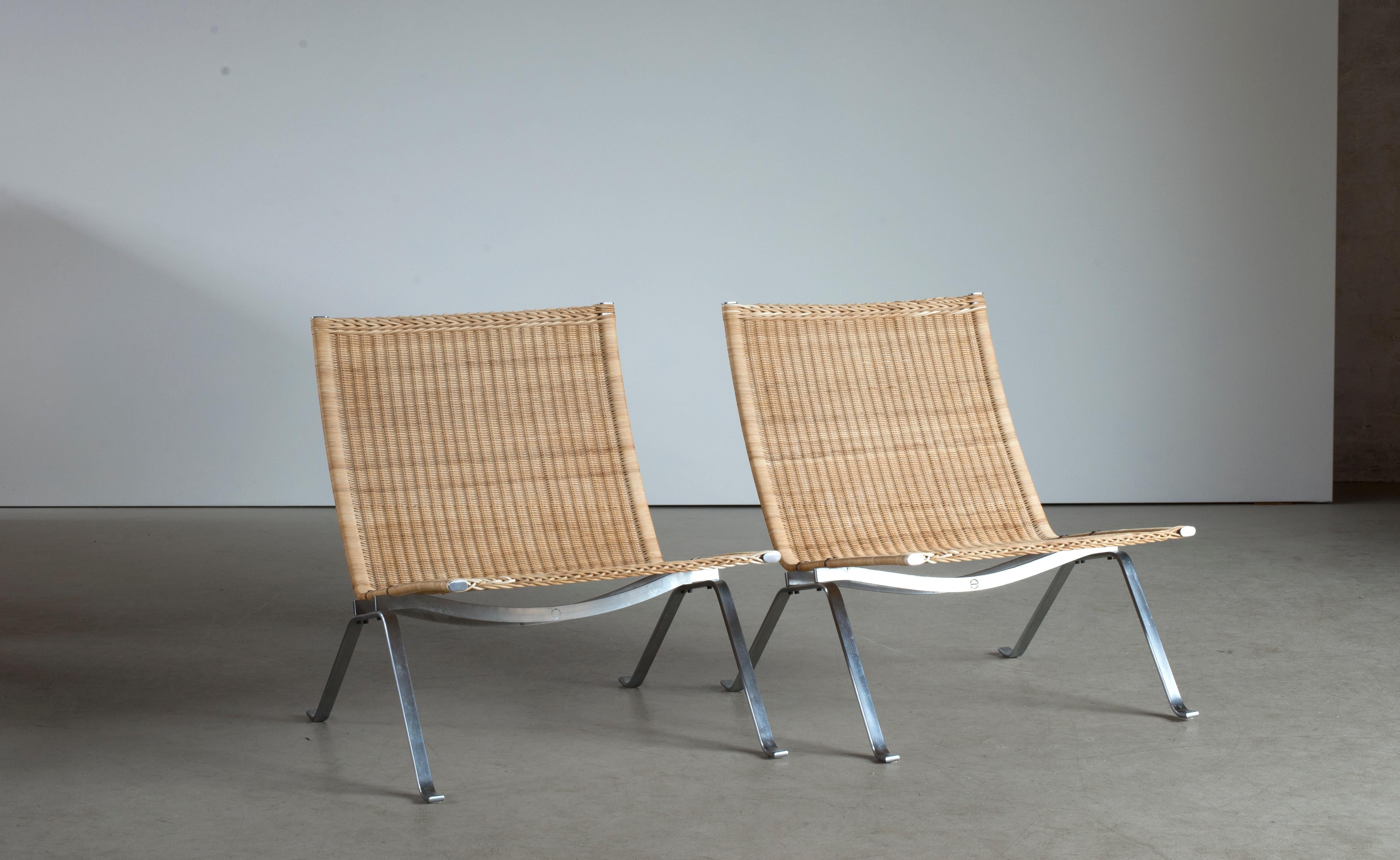 Poul Kjærholm two PK22 in steel and cane. Executed by Fritz Hansen, Denmark.
