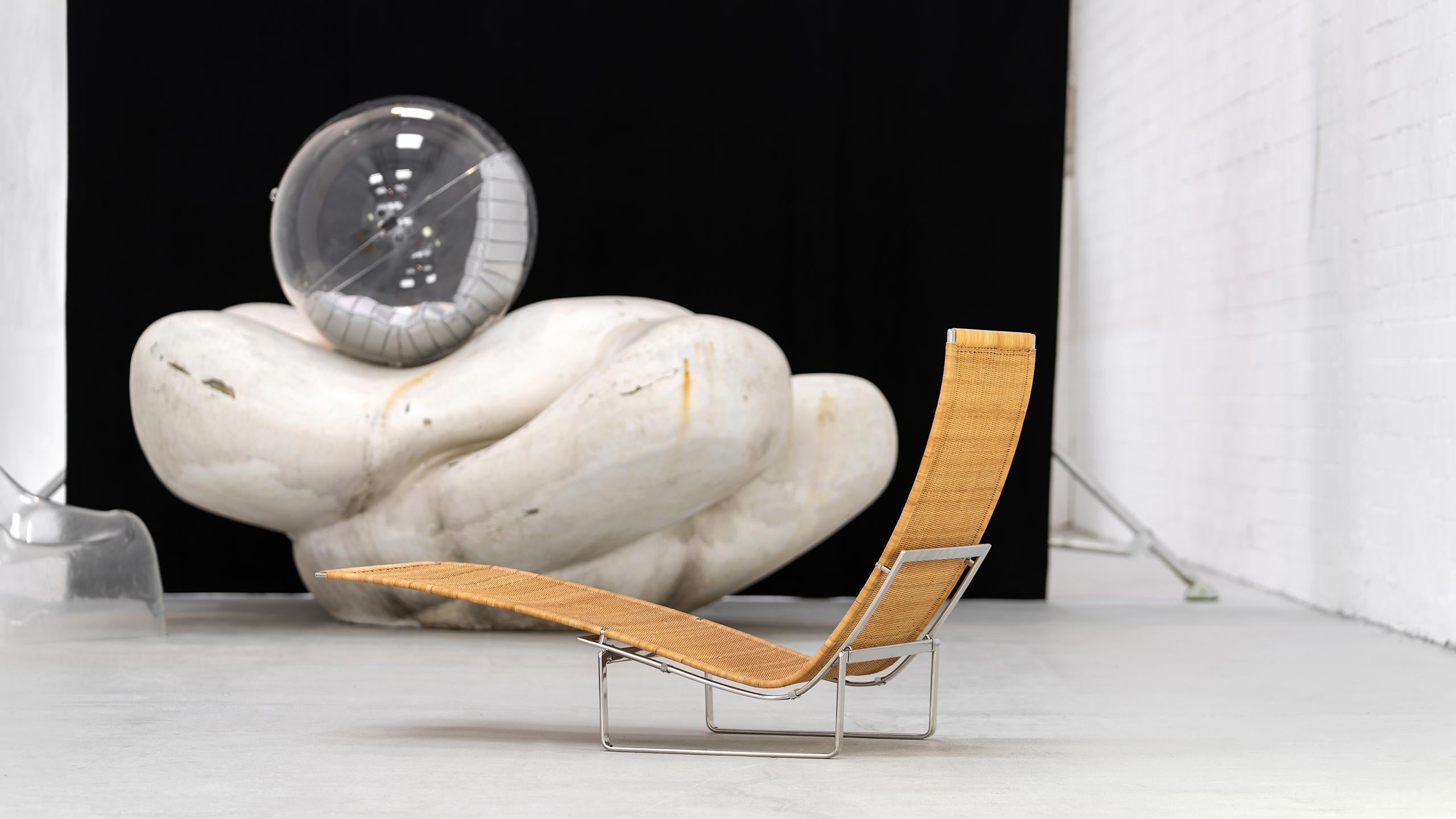 Poul Kjærholm 'PK24' Wicker Lounge Chair for Fritz Hansen with Leather Headrest.

Established in 1872, Fritz Hansen has become synonymous with legendary Danish design. Combining timeless craftsmanship with an emphasis on sustainability, the brand’s