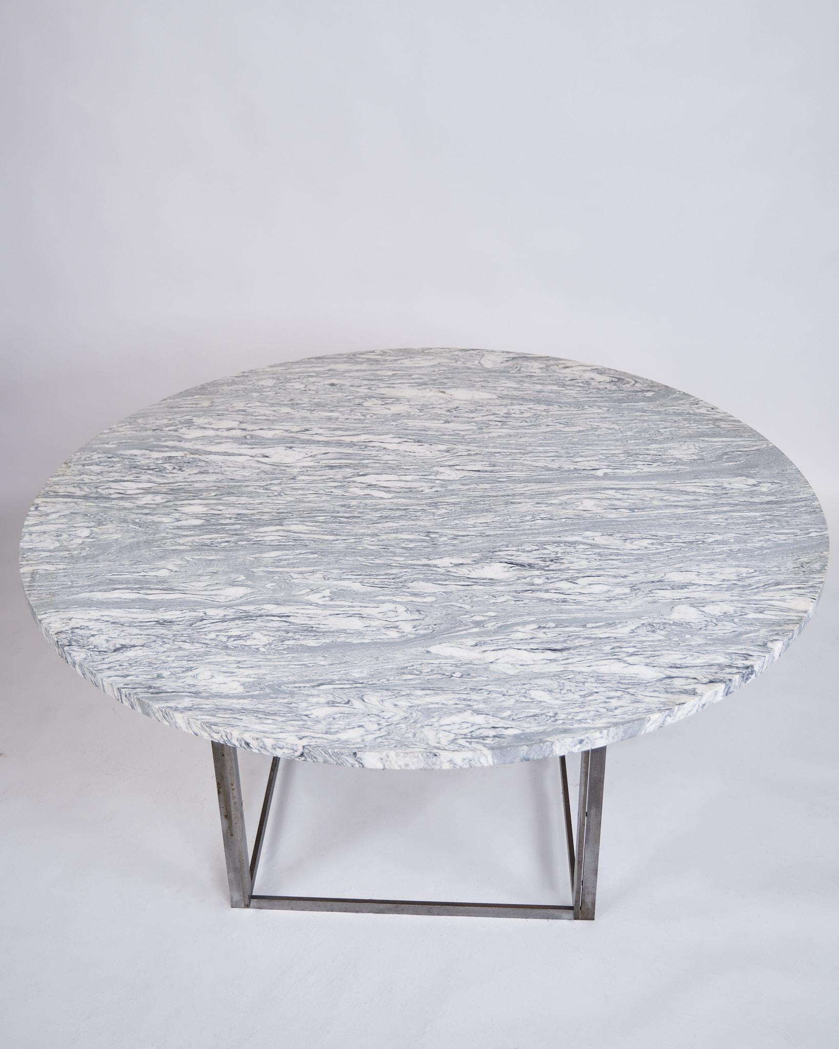 Rare dining table, model PK54, designed by Poul Kjærholm and produced by E. Kold Christensen in the 1960s. The table is made with a solid round cipollini marble top, supported by a steel frame, characteristic of Kjærholm's minimalist design.

It is