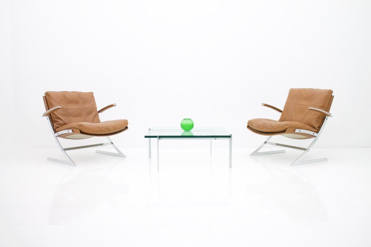 Coffee Table by Poul Kjaerholm, PK 61 made by E. Kold Christensen, Denmark 1956. Glass & Steel.

Very good condition.
    
Poul Kjærholm, one of Scandinavia's most famous furniture designers, chose his own style and did not work primarily with wood,