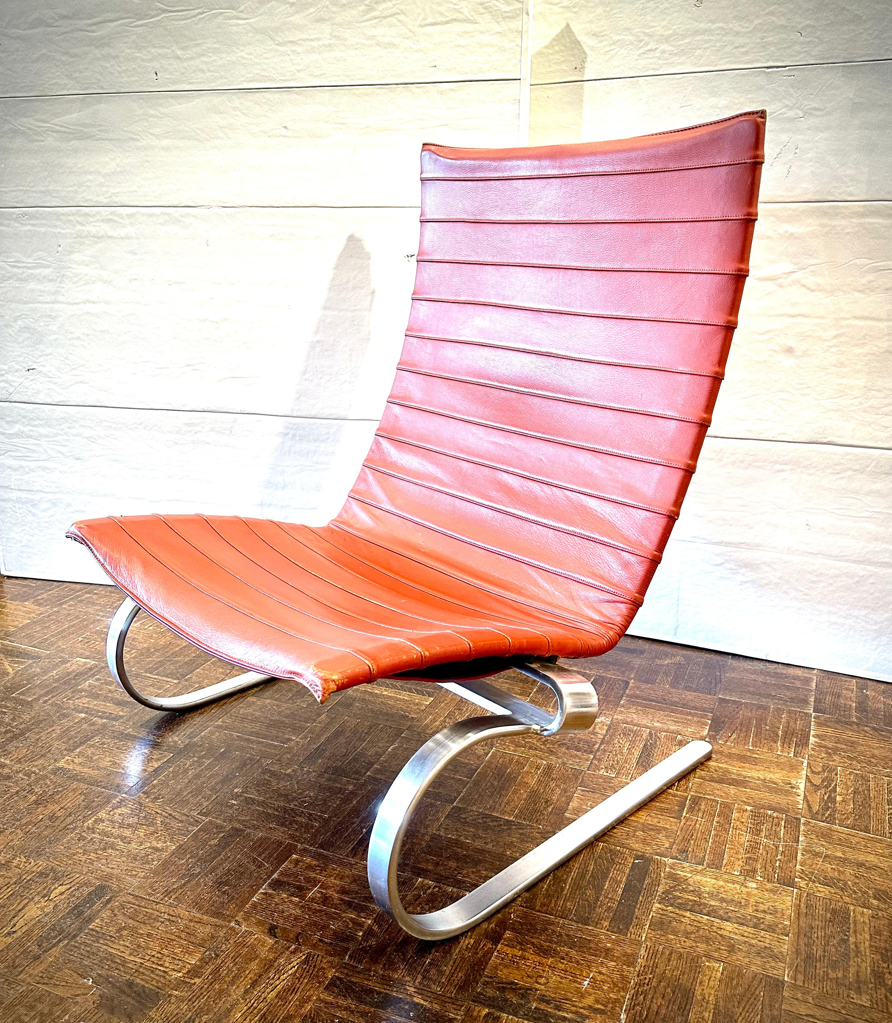 Cognac leather color, heavy steel frame, easy comfortable leather chair.  Designed by Poul Kjaerholm, made by Fritz Hansen.  C. 1990s Denmark.  
Wear appropriate to age.