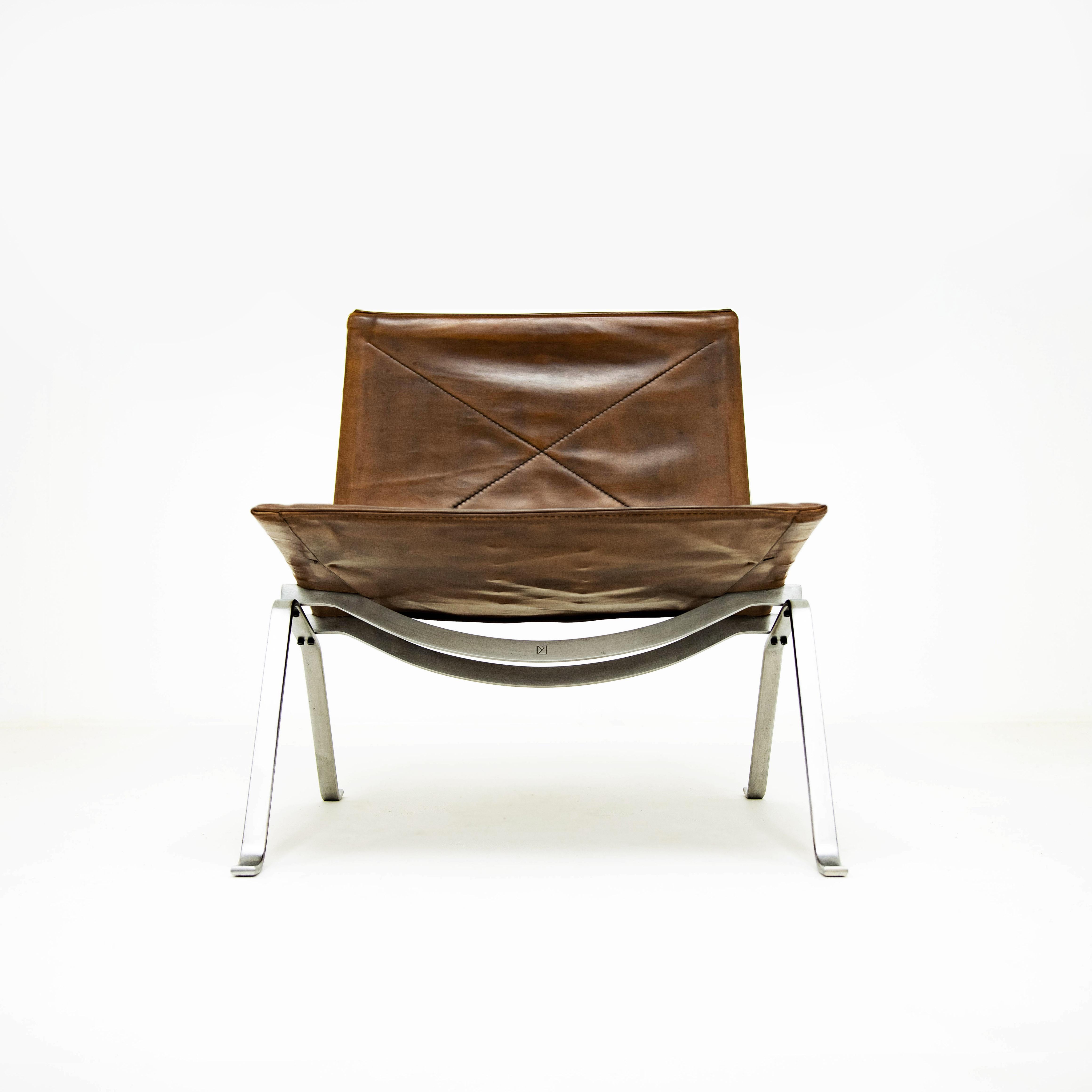 An early production Vintage Danish Mid Century Poul Kjaerholm PK22 Lounge chair in polished steel and cognac leather for E. Kold Christensen.

Originally designed in 1956 the PK22 stands out as one of Kjaerholm’s most lauded and recognised designs.