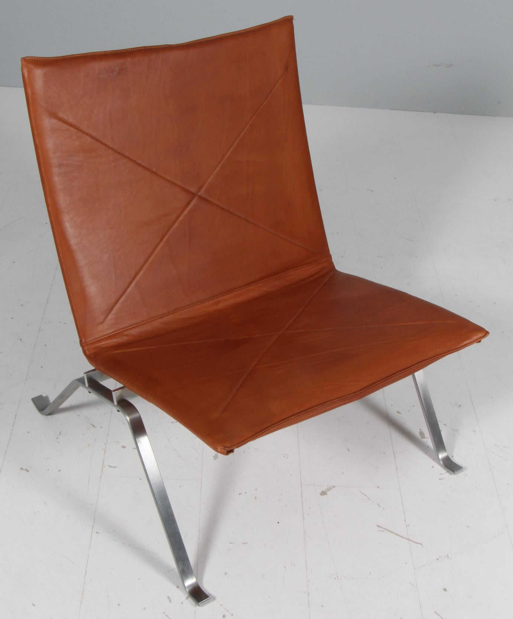Poul Kjærholm lounge chair new upholstered with cognac full grain aniline leather. 

Frame of brushed steel.

Model PK22, made by Fritz Hansen.