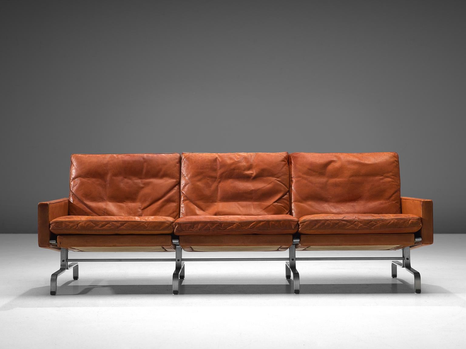 Poul Kjaerholm for E. Kold Christensen, three-seat sofa PK 31, leather and metal, Denmark, 1958.

Beautiful aged PK31 sofa in cognac leather by Poul Kjaerholm for E. Kold Christensen. This sofa features Poul Kjaerholm’s ability to work with
