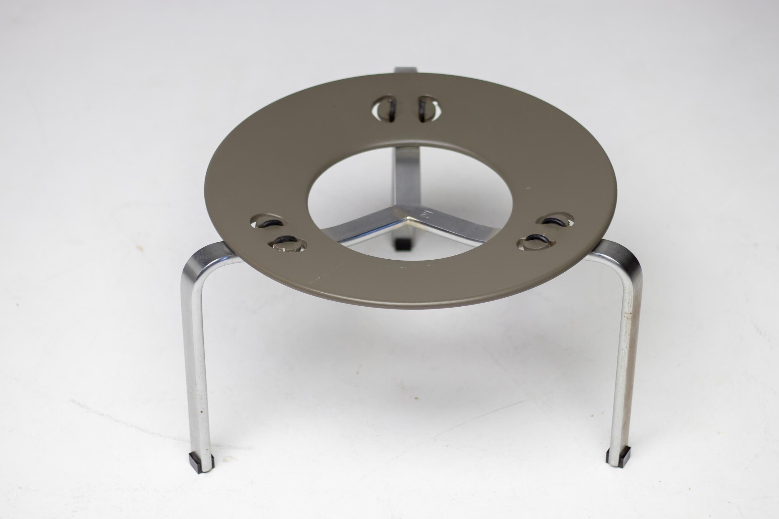 All original early production Poul Kjærholm by E. Kold Christensen PK33 stool.
Black leather seat pad and matte-chromed steel base with grey/green lacquered circular plywood seat support and rubber straps. The pads have the original 1st production