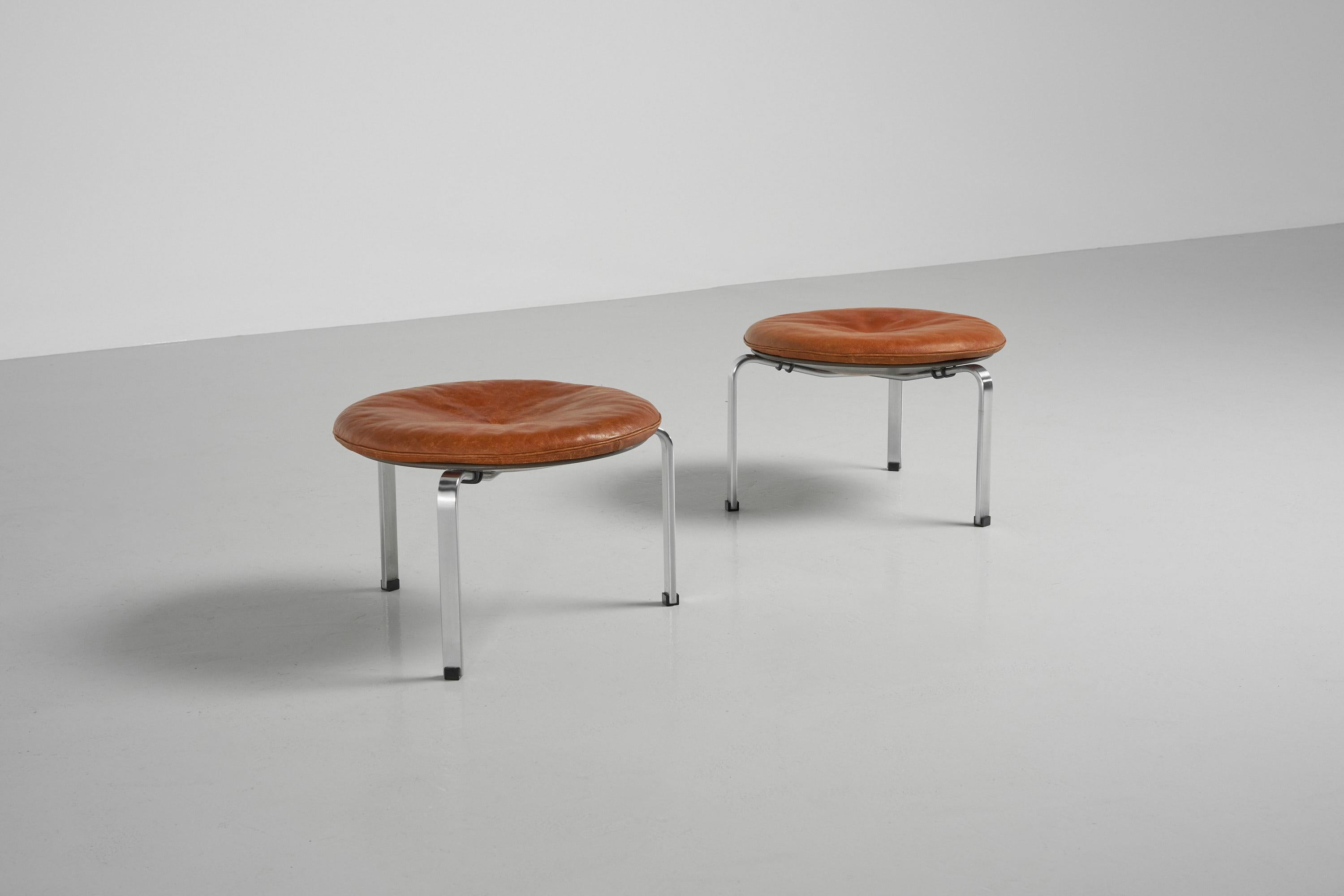 Amazing set of 2 model PK33 stools designed by Poul Kjaerholm and a first production manufactured by Ejvind Kold Christensen, Denmark 1959. This pair of stools has a matt chrome plated spring steel frame with black plastic floor protection feet. The