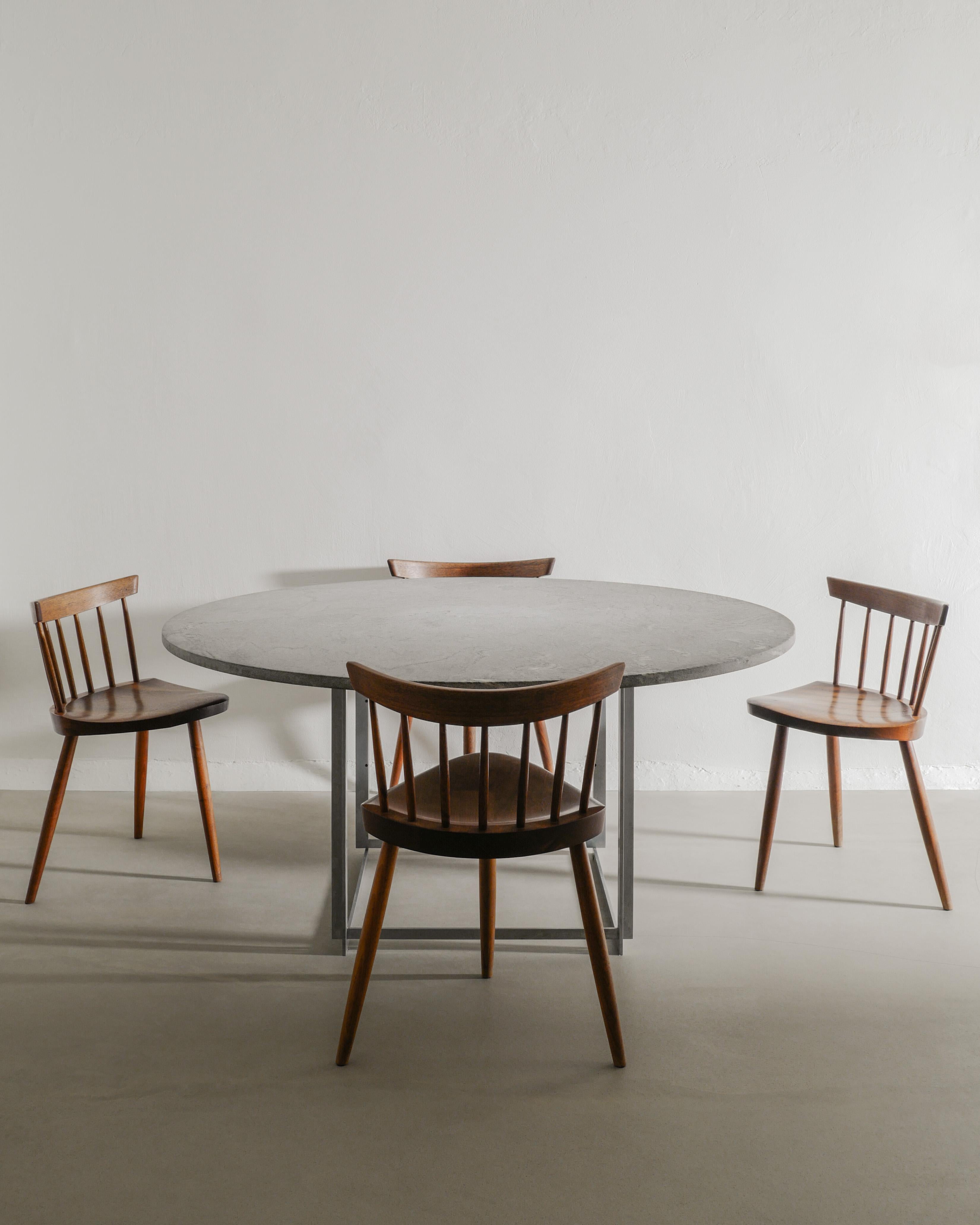 Rare set of Danish and American mid century dining set by Poul Kjærholm and Mira Nakashima. The iconic round PK54 table with cippolini marble and steel base is produced and stamped by E. Kold Christensen and matches well with a set of four wooden