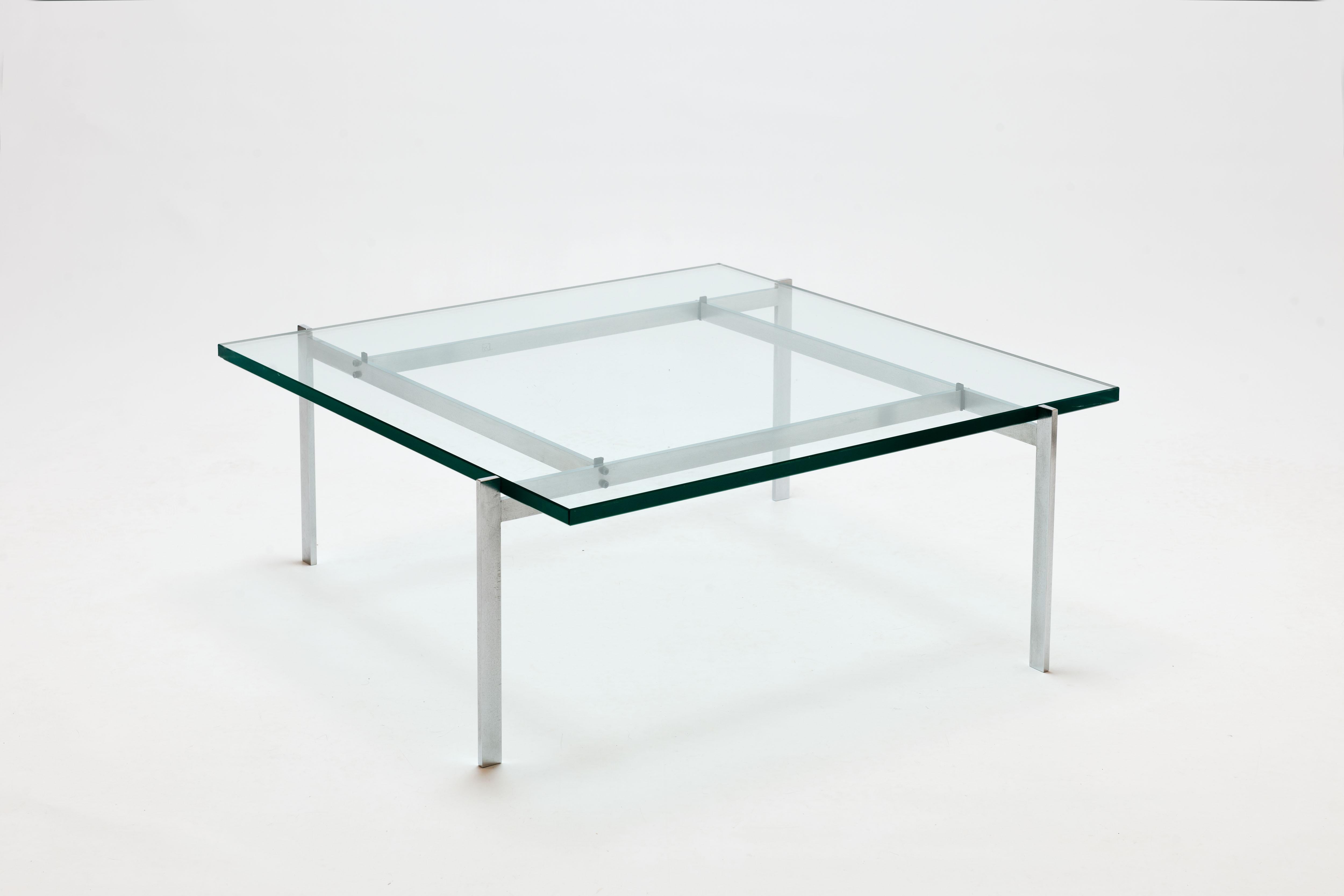 Coffee table model PK61 with transparent glass top. Matt chrome-plated steel base in perfect proportions. 
This aesthetic design serves as a powerful manifesto, depicting Kjærholm's development from Industrial designer to exceptional furniture