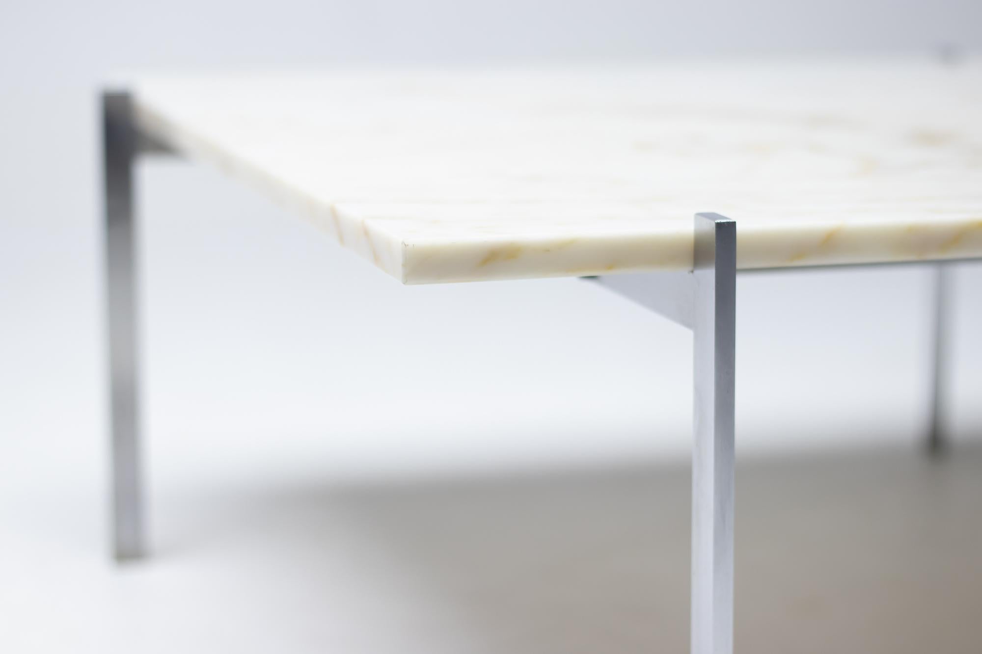 Poul Kjærholm for E. Kold Christensen, white marble and steel, Denmark, designed in 1955. 
Marked with E. Kold Christensen logo in the frame.

This table by Kjærholm is the epitome of minimalistic yet monumental design. The 'swastika' shaped