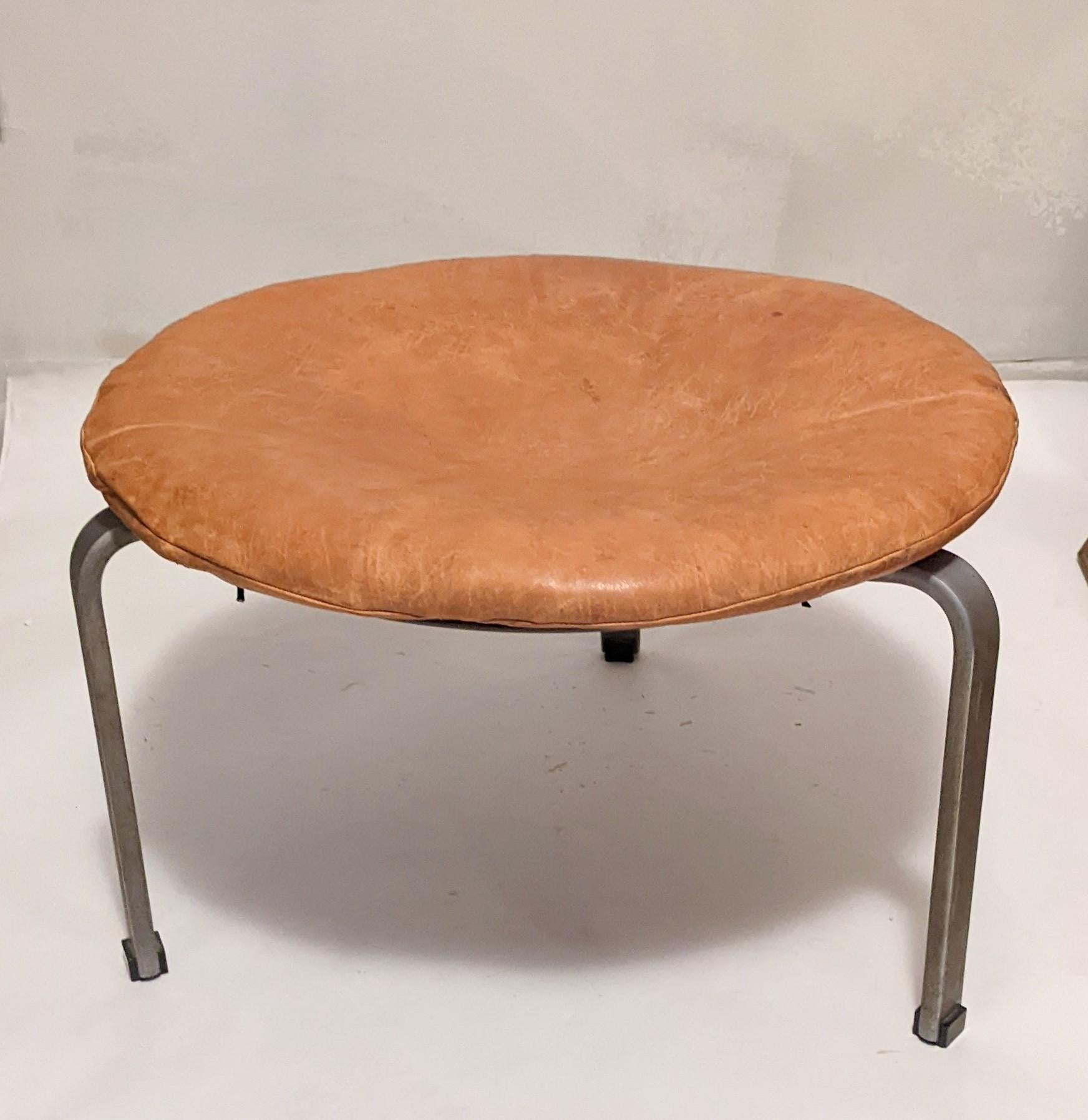 Rare stool model PK-33 designed by Poul Kjærholm. Produced by E. Kold Christensen in Denmark with painted grey wood base and circular brushed satin steel frame and cognac leather cushion (not original). 1960's.