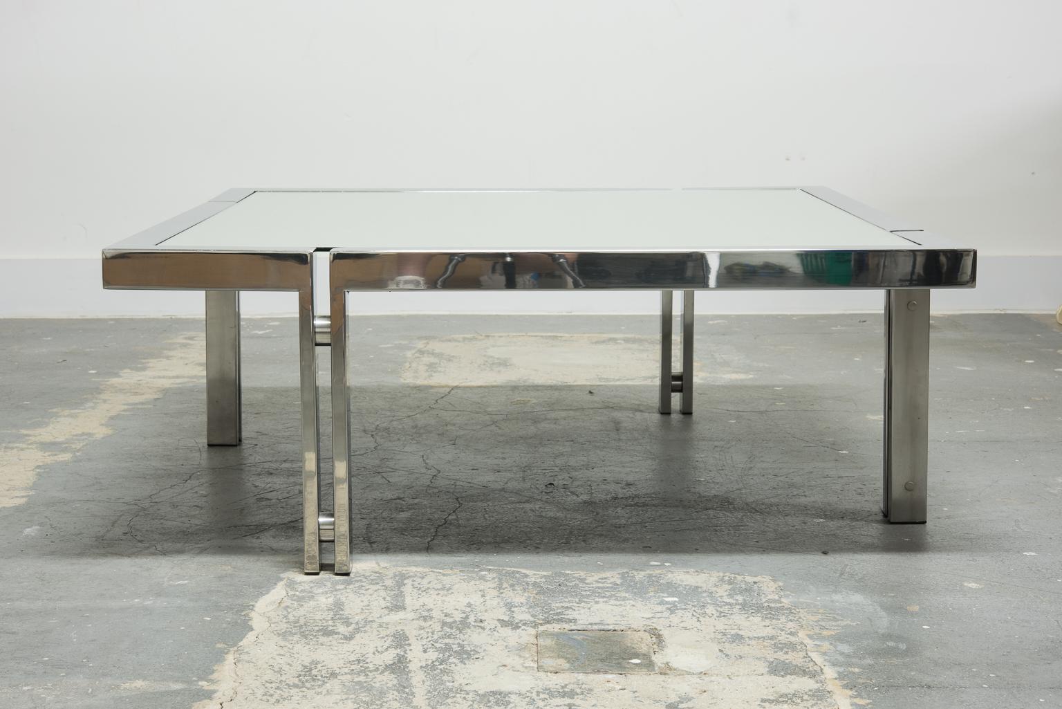 This amazing modern coffee table features a mirrored top and four offset legs similar to Poul Kjaerholms PK-61 tables except with double legs separated with a chrome spacer. Came from a very high-end designer home in Los Feliz Hills in Los Angeles,