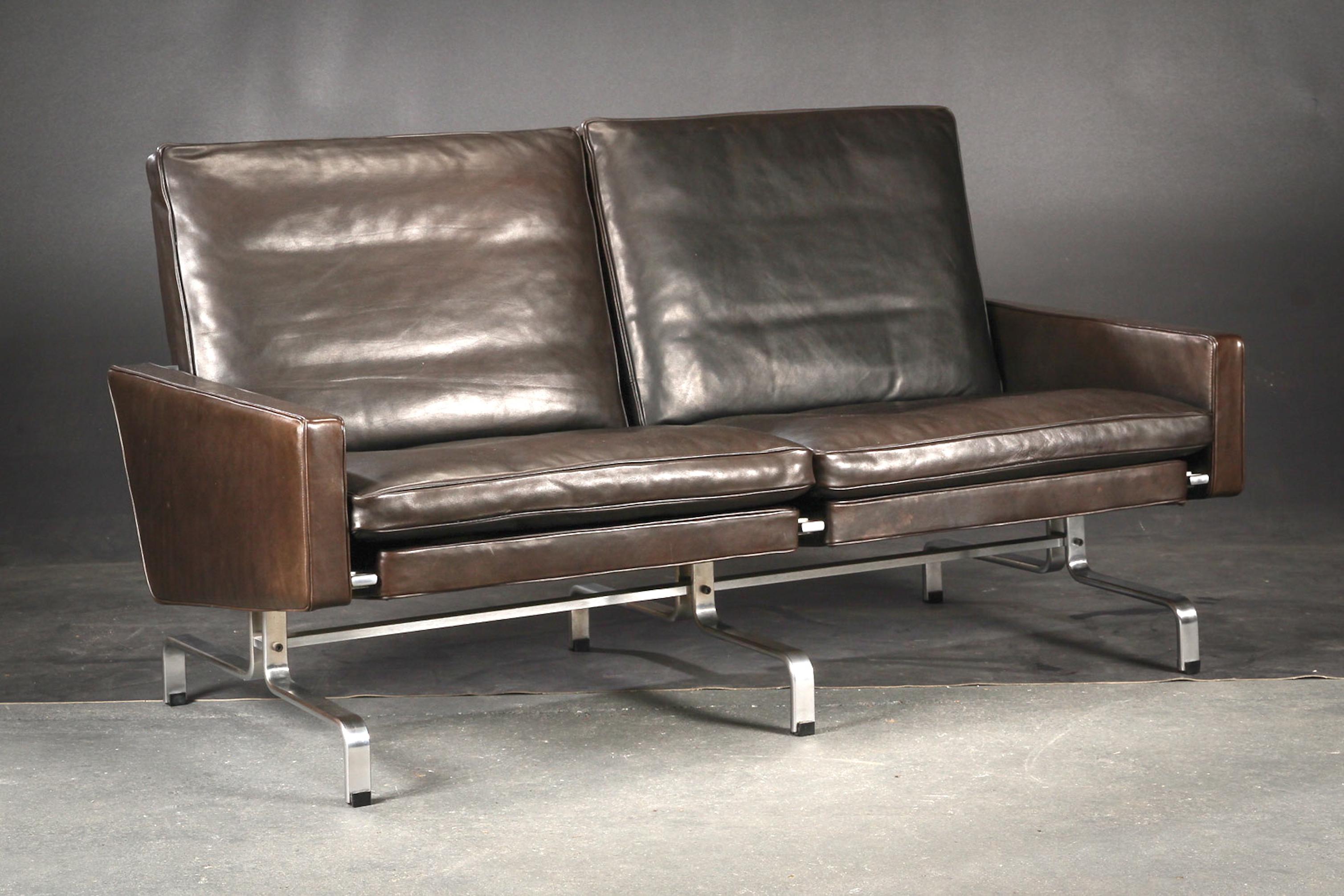 A two-seat sofa designed by Poul Kjaerhom and edited by Kold Christensen in 1958. Stamped.Frame in chromed steel. Back, sides and loose cushions upholstered in original black 