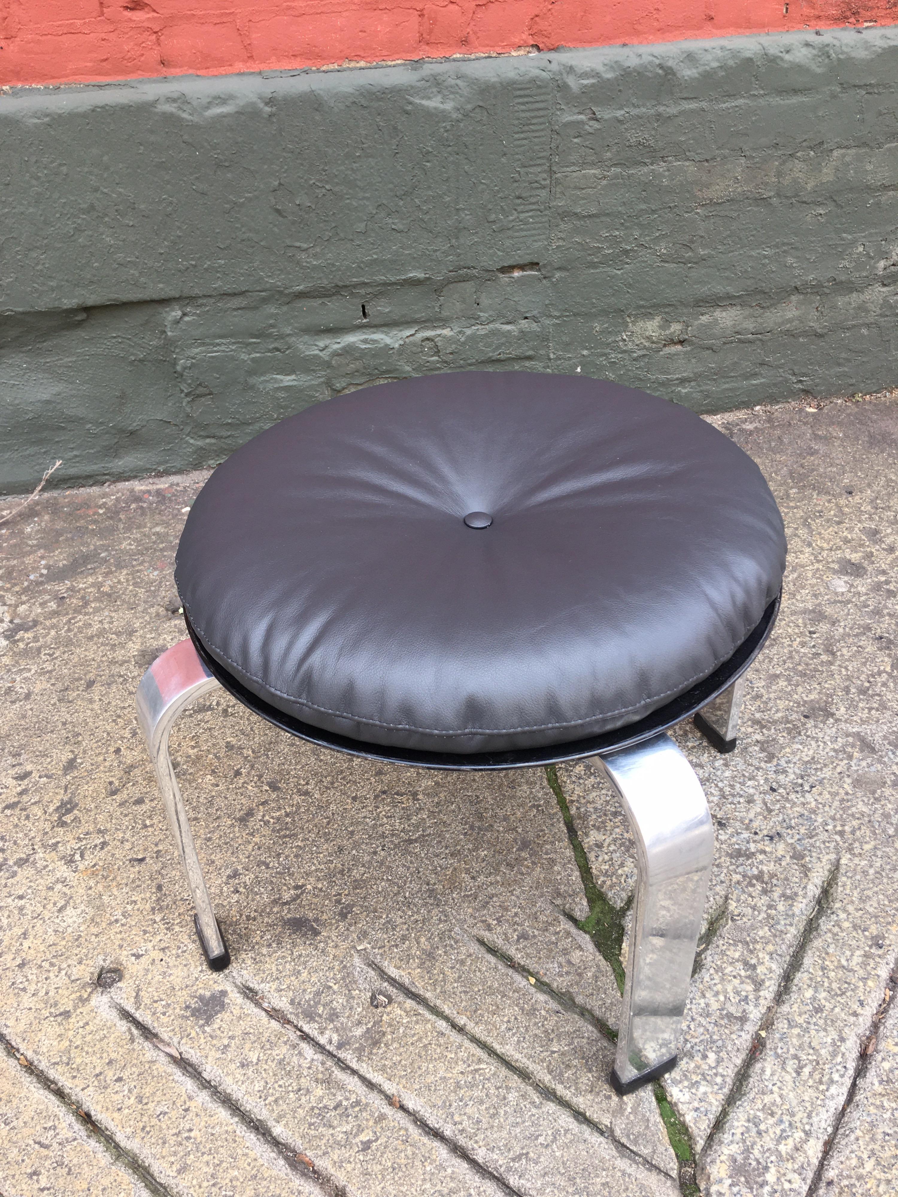Poul Kjaerhorm style stainless steel and leather ottoman/ stool. New dark brown leather cushion. Retains all of its original plastic feet.
