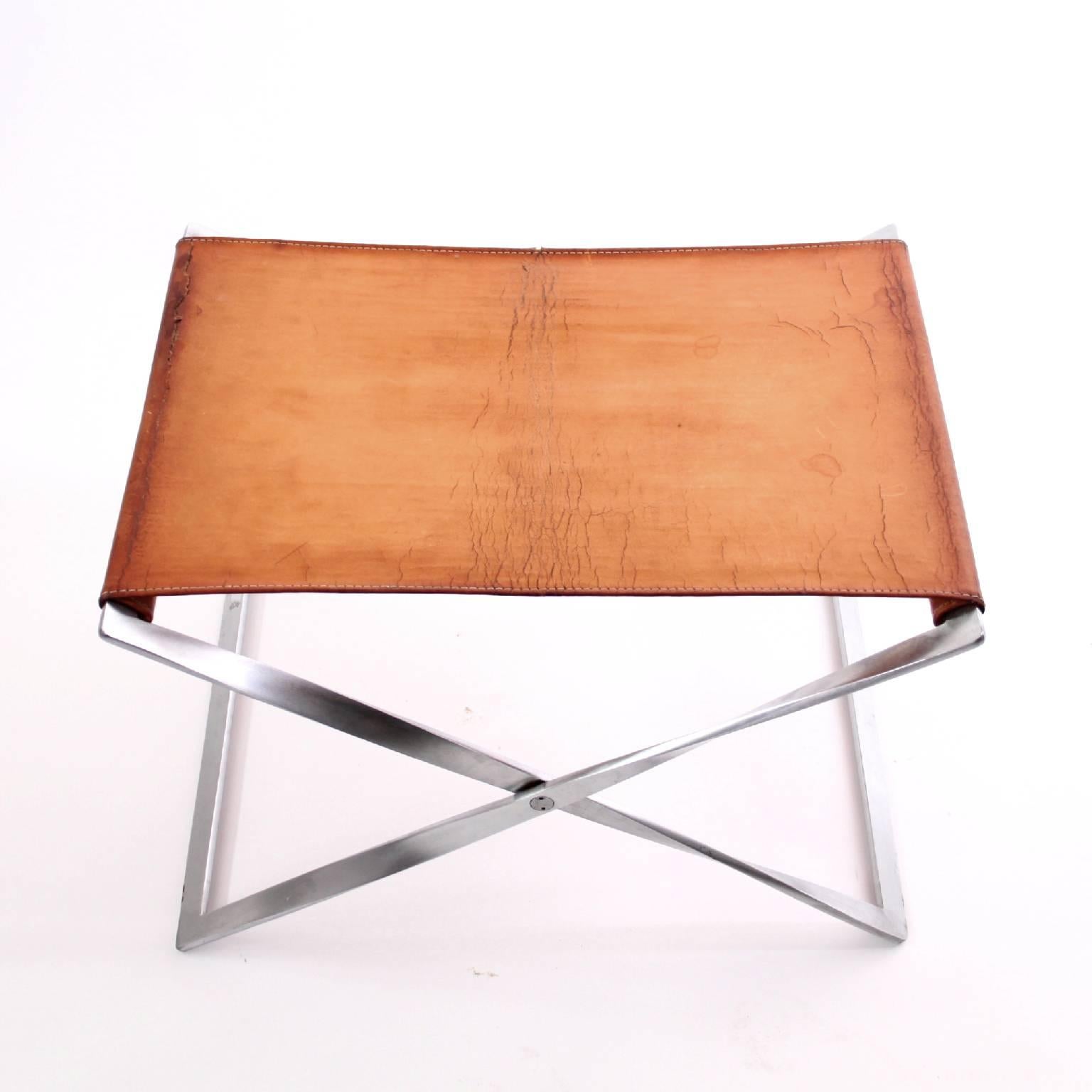 PK 91 folding stool by Poul Kjærholm.

Designed 1961.

Manufactured by E. Kold Christensen A/S, Copenhagen, Denmark.

Materials: original natural leather, matte, chromed-plated steel frame.

A trained cabinetmaker, Poul Kjærholm’s use of