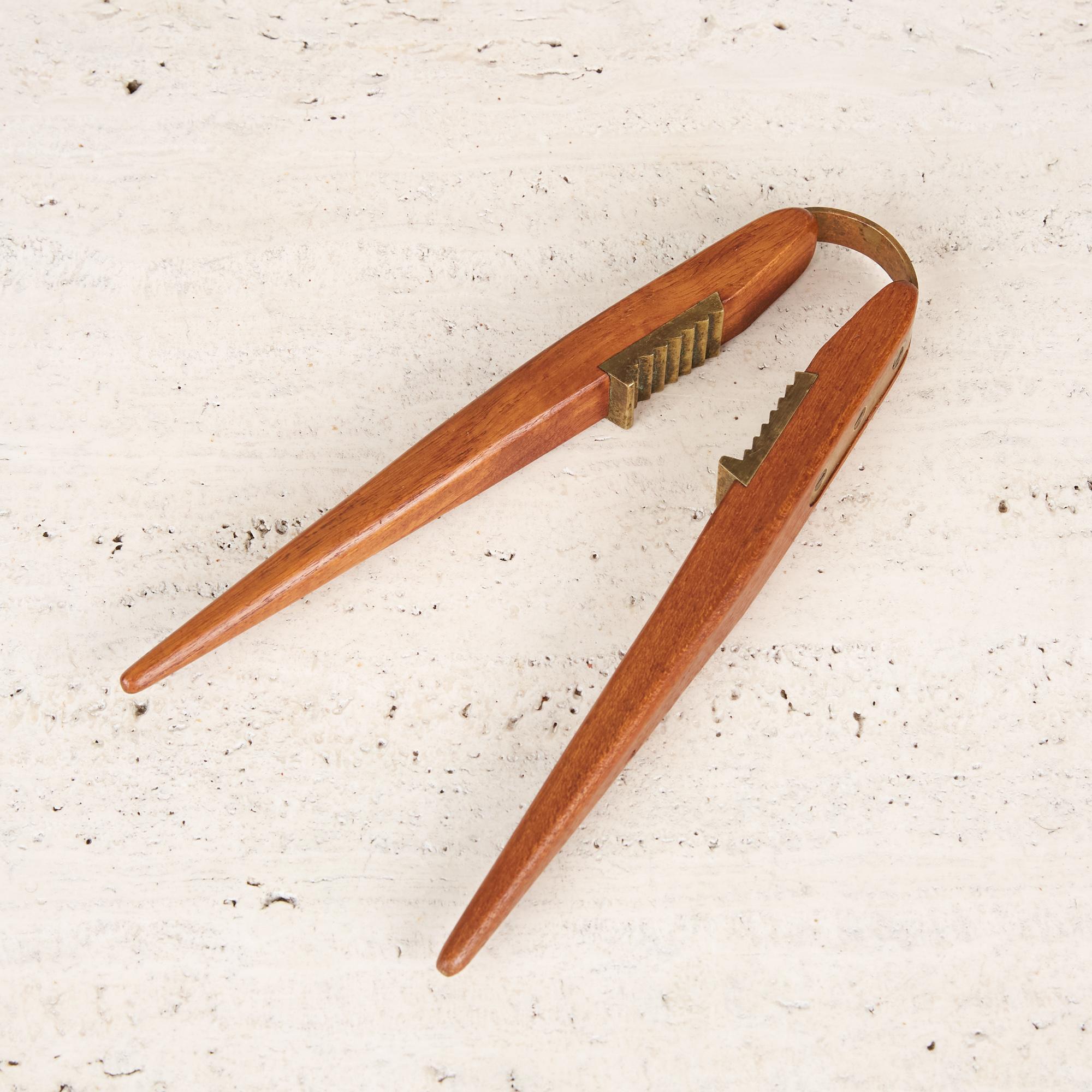A very clever design dating back to the 1950s, this Poul Knudsen teak and brass nutcracker utilizes a piece of bent brass that acts as a spring mechanism making it possible to crack an entire bowl of nuts in under 2 minutes (we know, because we