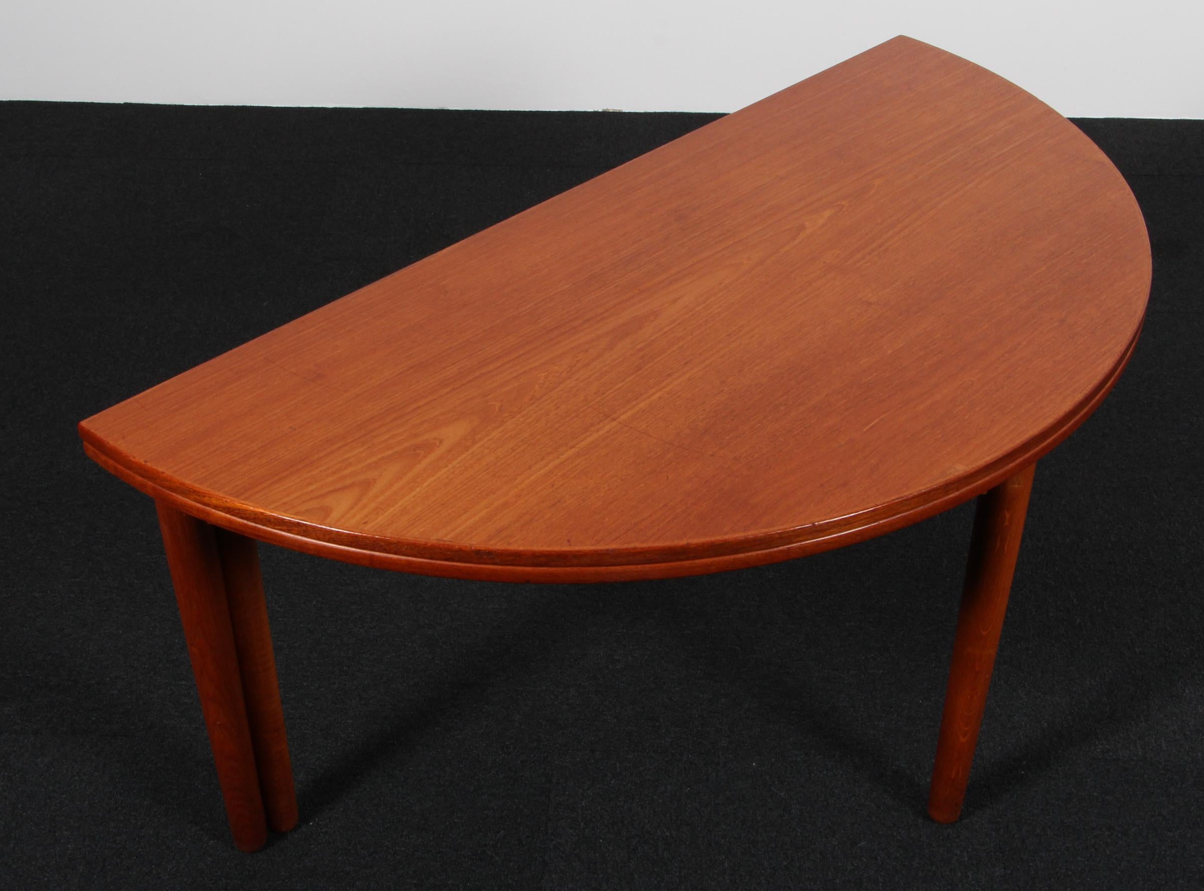 Poul M. Volther half circle coffee table with flip flop top. Top of veenered teak. Base of solid oak.