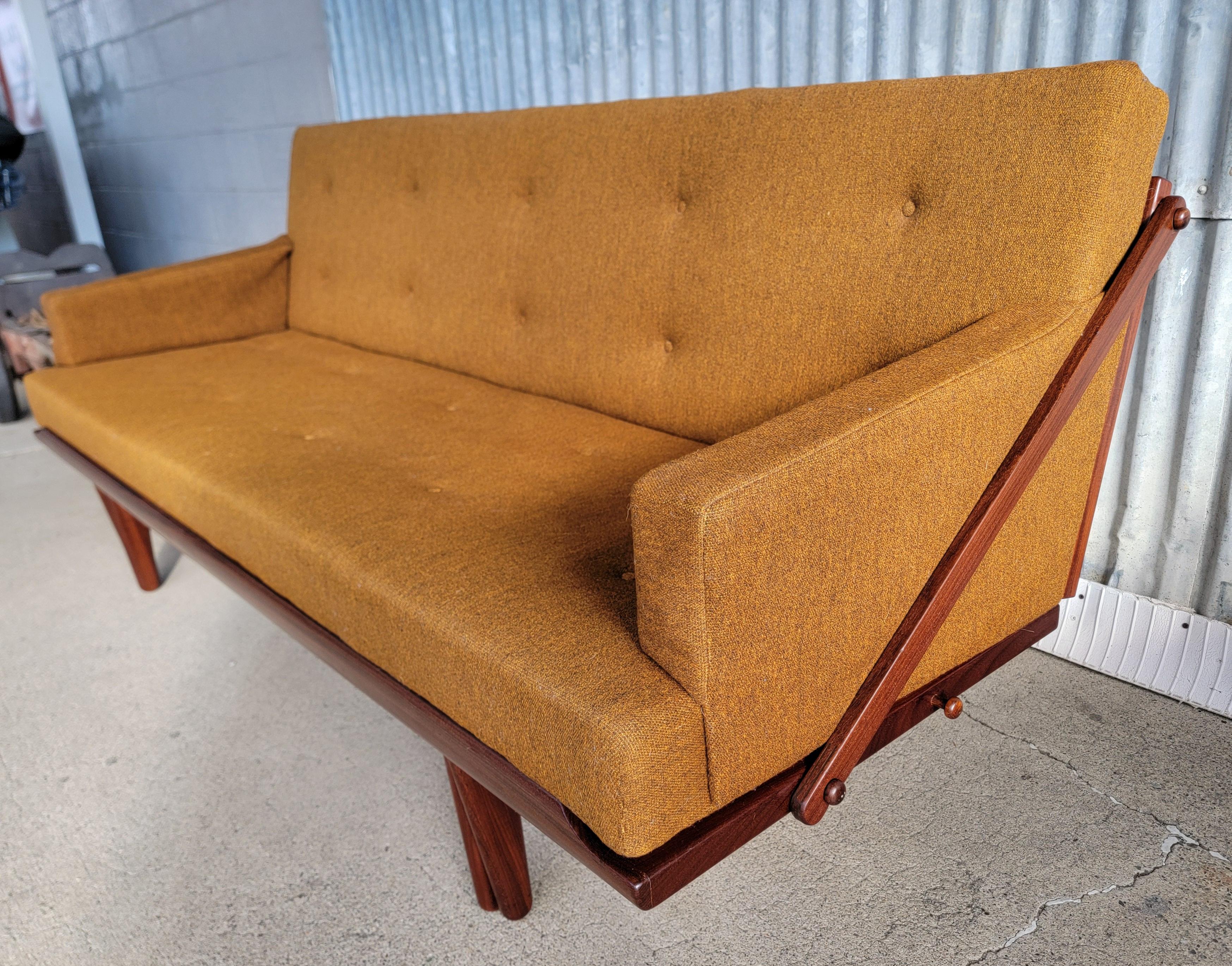 A Danish Modern sofa sleeper designed by Poul M. Volther for Frem Røjle. Denmark, circa. 1960's. Converts from sofa to bed by simply sliding the frame forward. Beautiful original finish to solid teak frame stained with a rosewood finish. Sofa rests