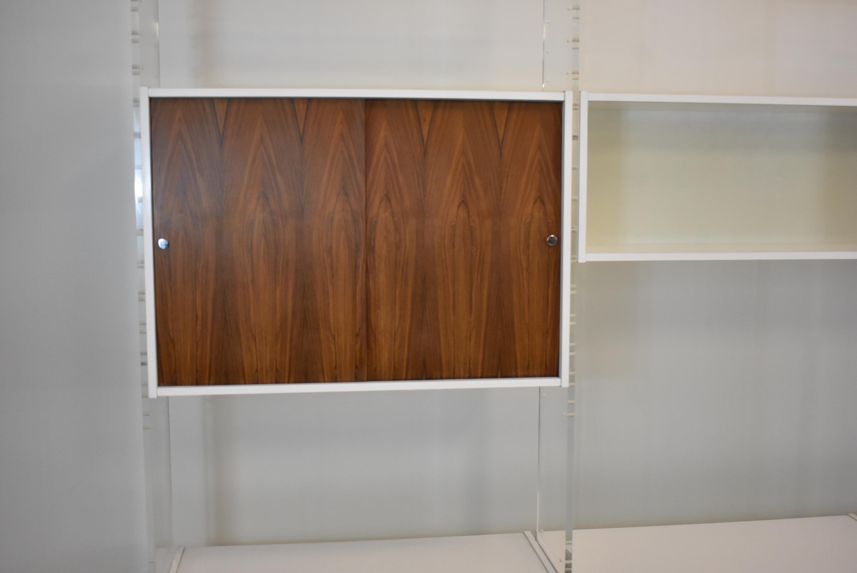 Poul Norreklit for Georg Petersens Mobelfabrik acrylic and rosewood modular free standing storage unit with shelves and cabinets. Beautiful sliding doors in Brazilian rosewood. Four lucite panels mounted on an aluminum base. Adjustable shelves. 101