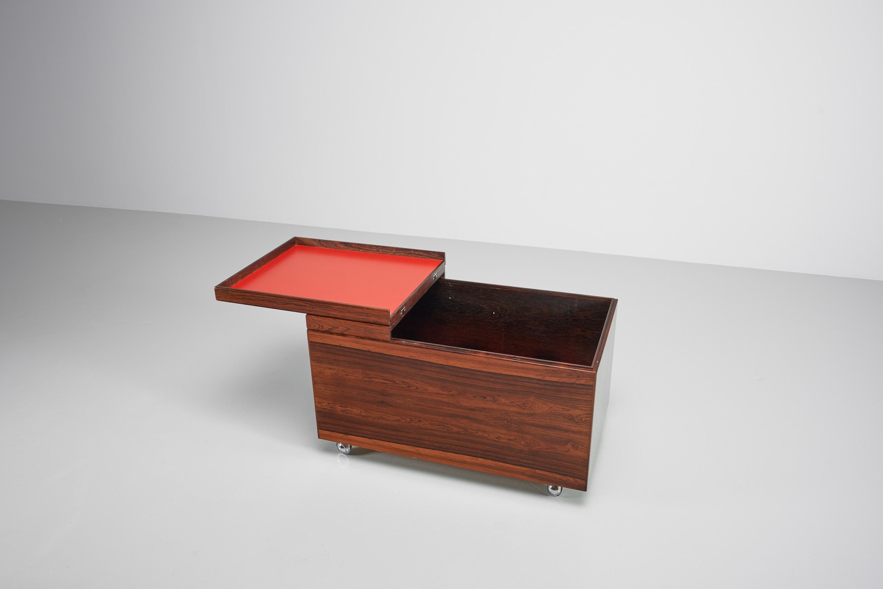 Very rare and beautifully preserved dry bar cabinet designed by Poul Norreklit and manufactured by Dyrlund in Denmark in 1960. This dry bar has a striking dark Rosewood grain running horizontally all over the veneer and has very simplistic details