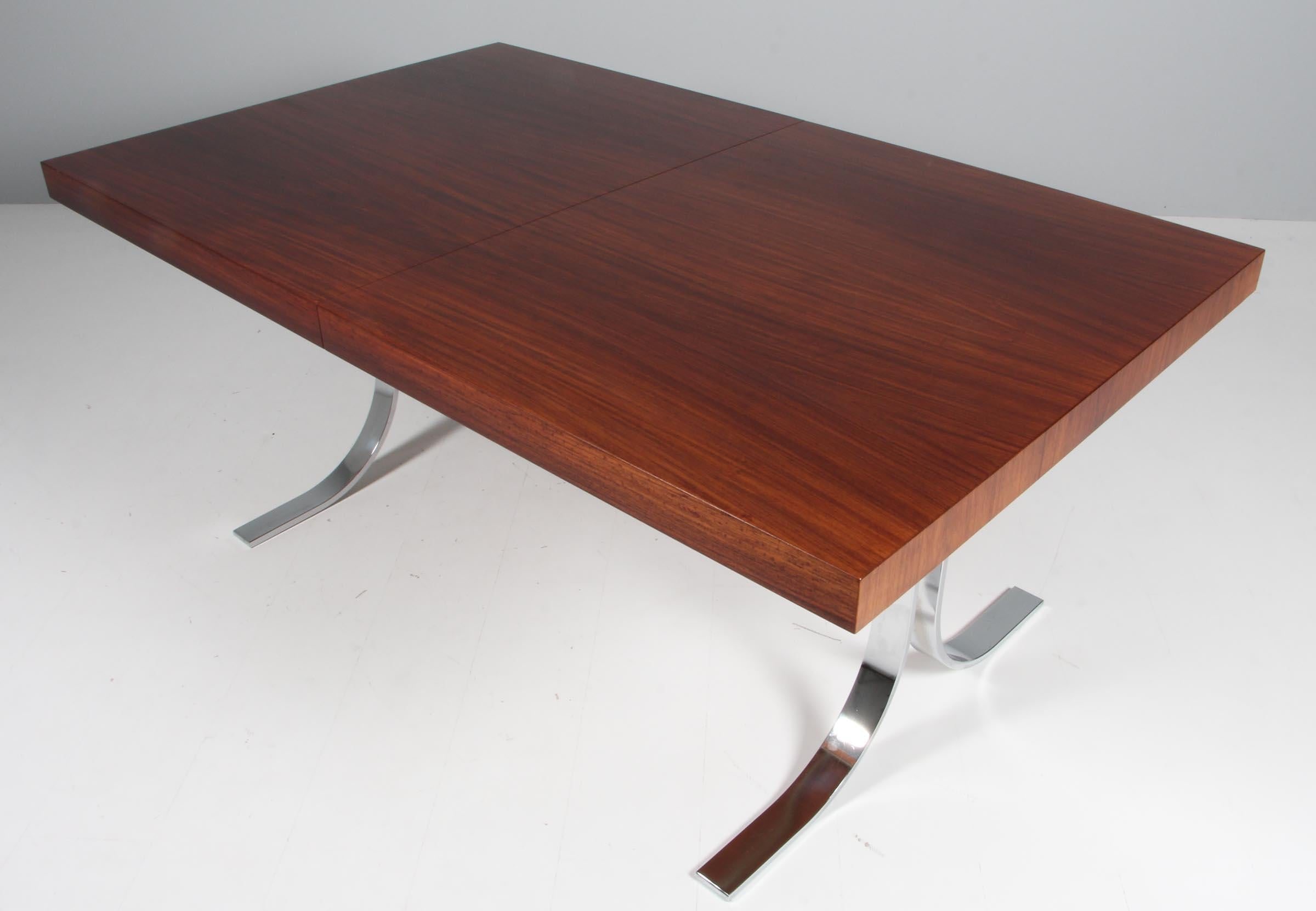 Poul Nørreklit dining table in rosewood with one extension leaf.

Frame of chromed steel.