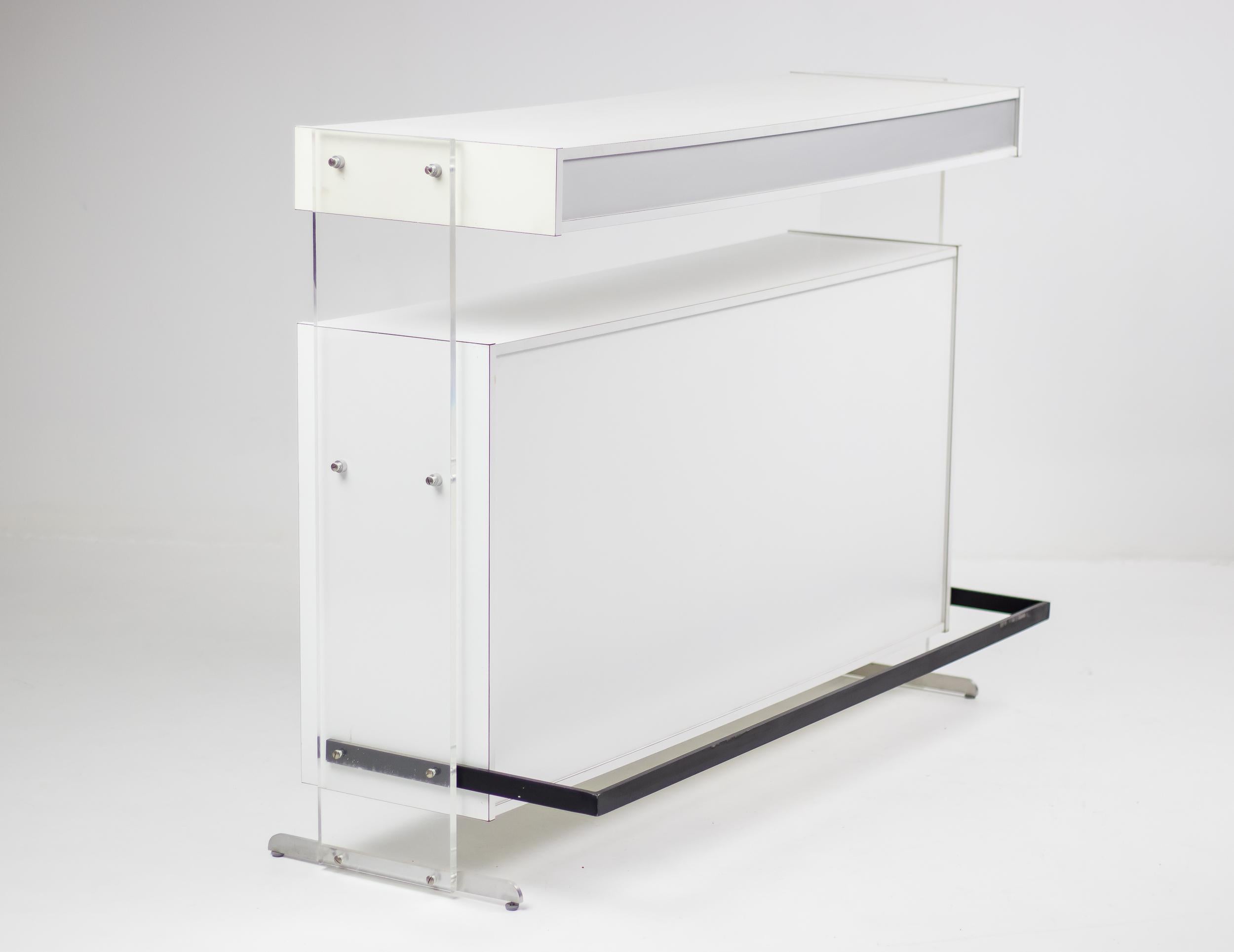 Architectural dry bar designed by Poul Nørreklit in 1969 and made by Georg Petersens Møbelfabrik. 
Made in white and silver laminate with acrylic supports on aluminium legs. Great futuristic 