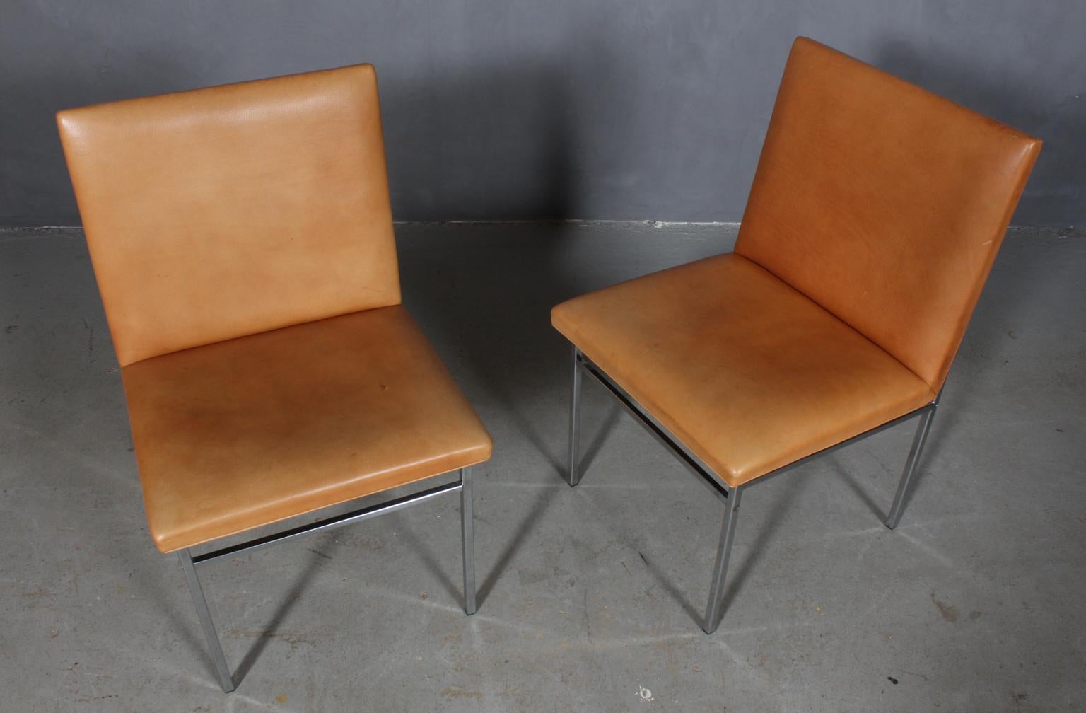 Poul Nørreklit set of chairs with original tan leather uphoistery.

Frame of chromed steel.