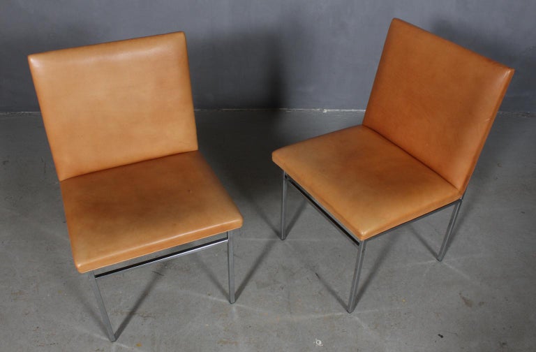 Poul Nørreklit set of chairs with original tan leather uphoistery.

Frame of chromed steel.