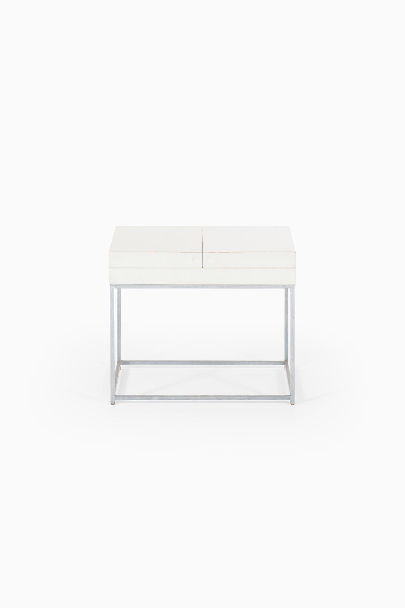 Side table in steel and white lacquered wood designed by Poul Nørreklit. Produced by Selectform in Denmark.