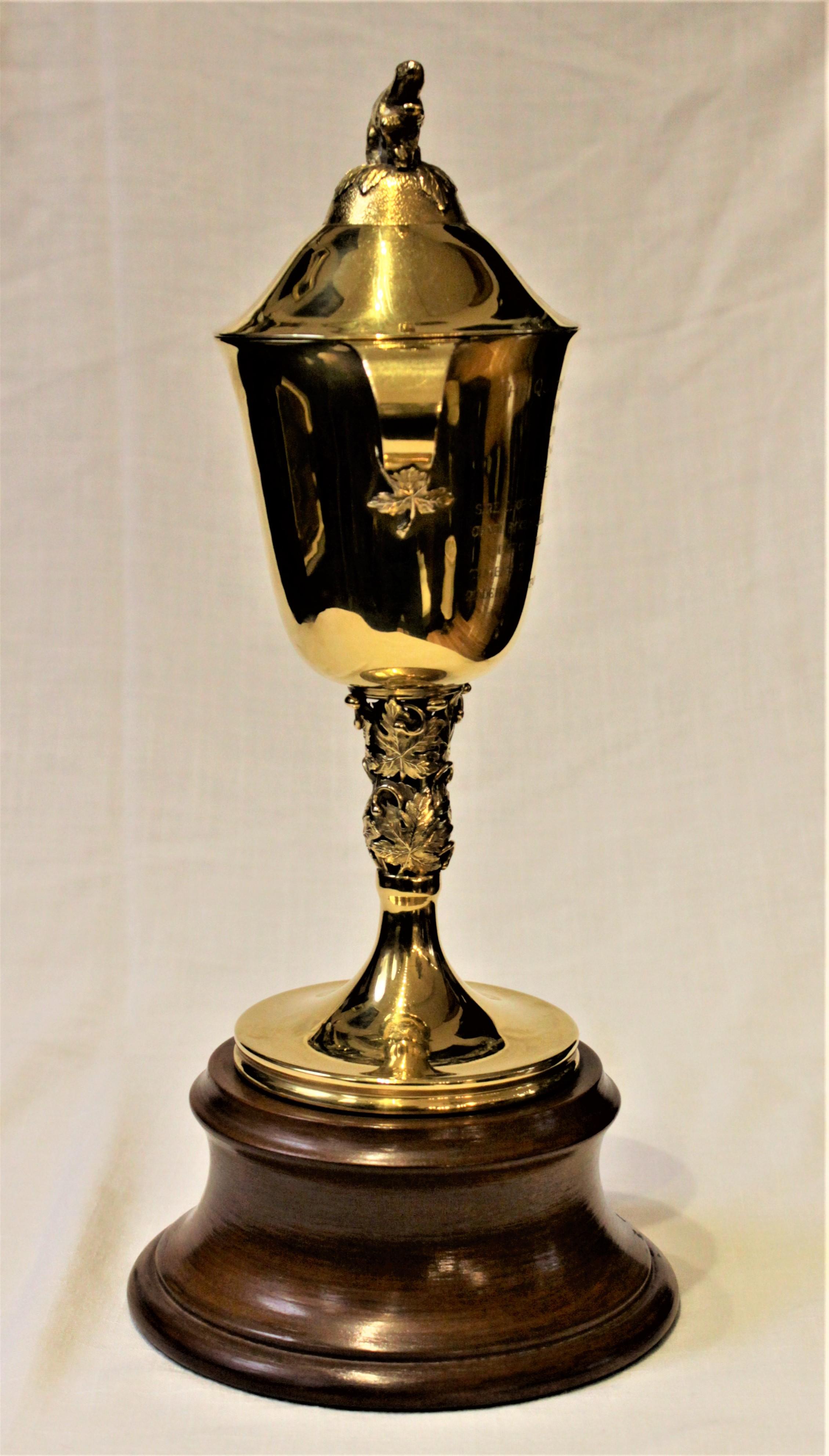 This solid 14-karat yellow gold Queen's Plate Stakes horse racing trophy was made by renowned Danish Canadian silversmith, Carl Poul Petersen for Mappins of Montreal for the 1961 running at Woodbine. The trophy incorporates iconic Canadian symbols