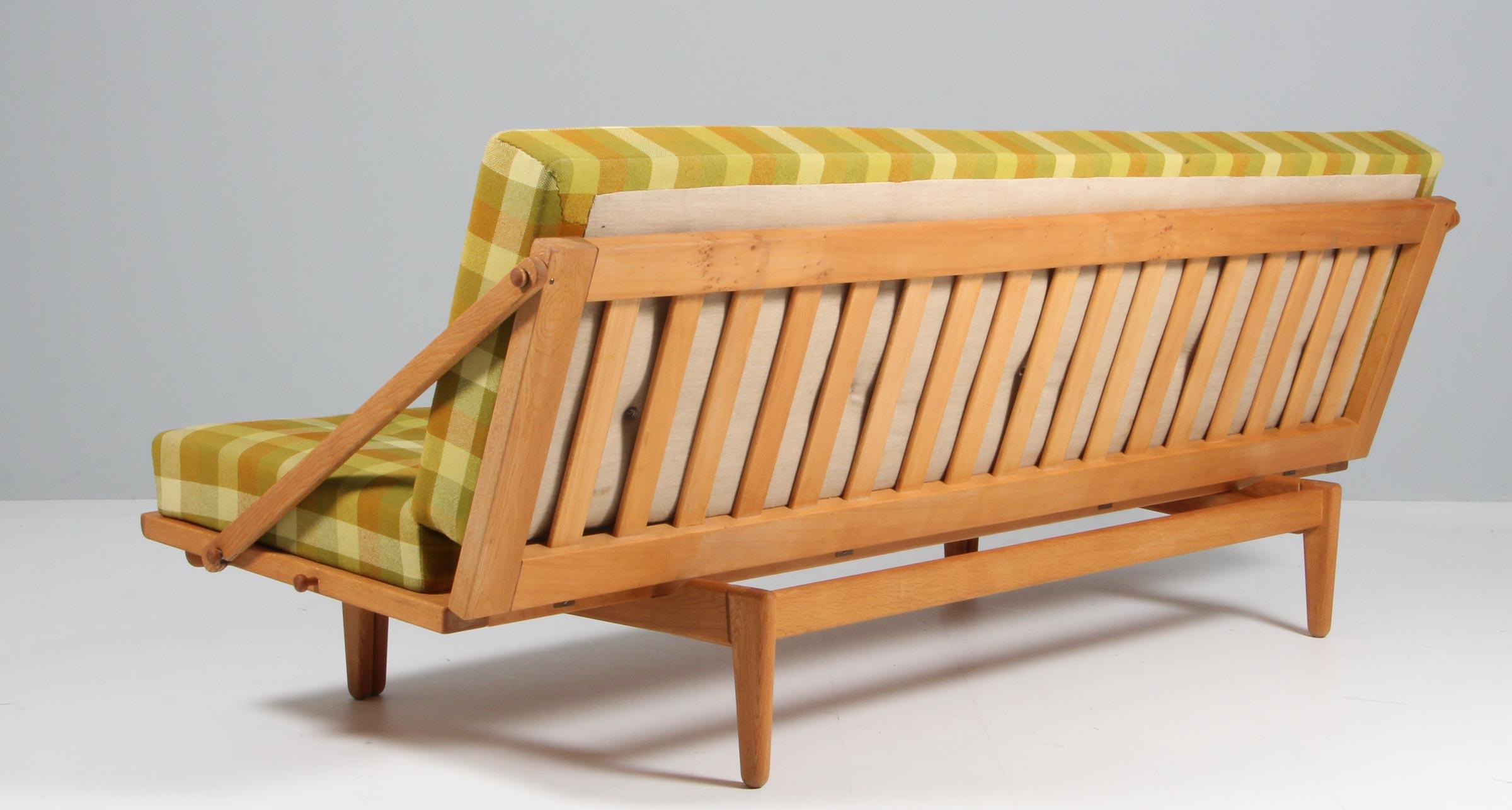 Very nice sophisticated daybed sofa Model 981 designed by Poul M Volther and manufactured by Frem Røjle, Denmark, 1959. This sofa is called 'Diva' and has a solid oak structure which can be folded down to create a daybed. Multi functional sofa. The