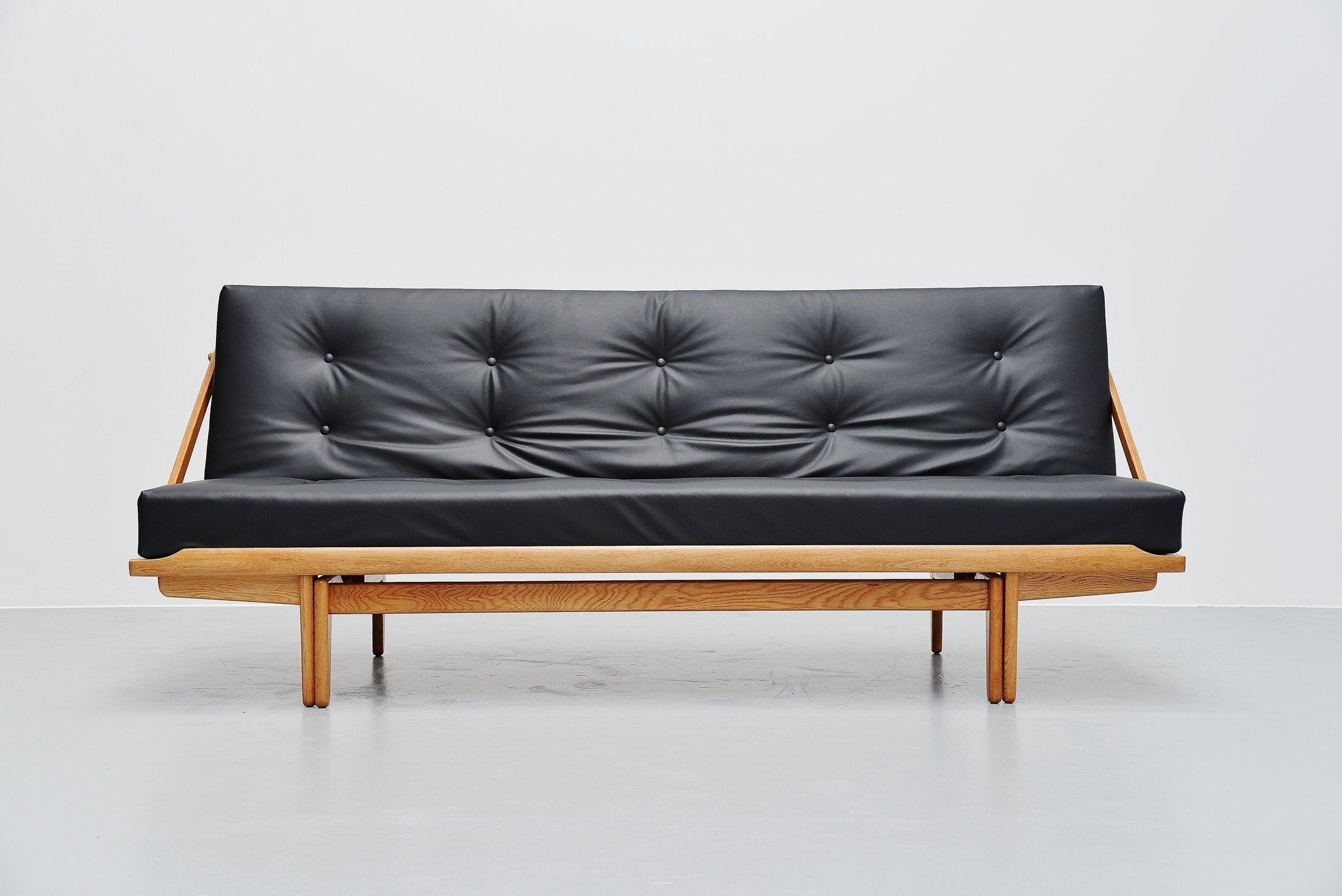 Very nice sophisticated daybed sofa Model 981 designed by Poul M Volther and manufactured by Gemla, Denmark, 1959. This sofa is called 'Diva' and has a solid oak structure which can be folded down to create a daybed. Multi functional sofa. The sofa