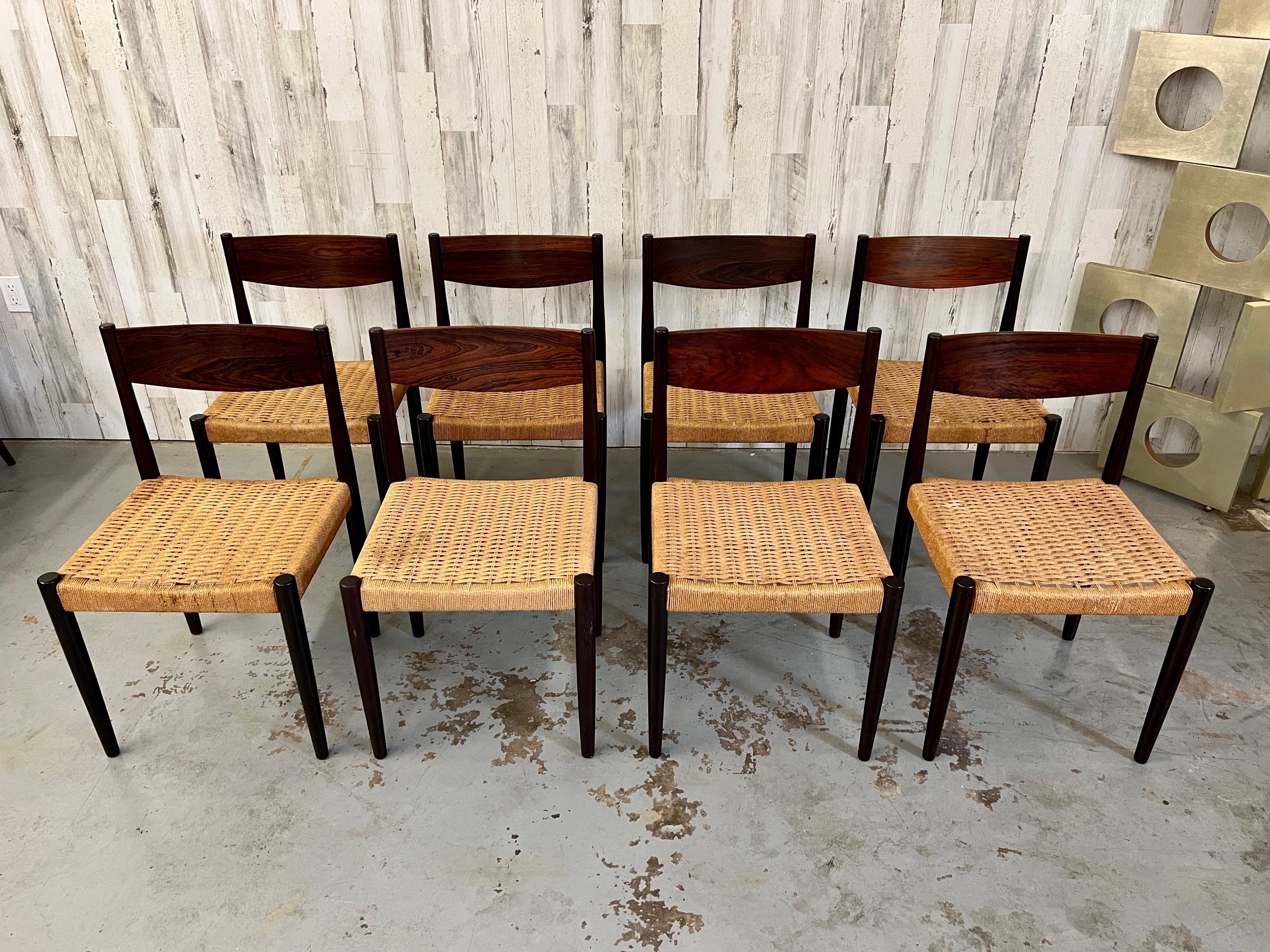 Set of eight sculpted rosewood with Danish cord seat dining chairs in very well cared for original condition.
