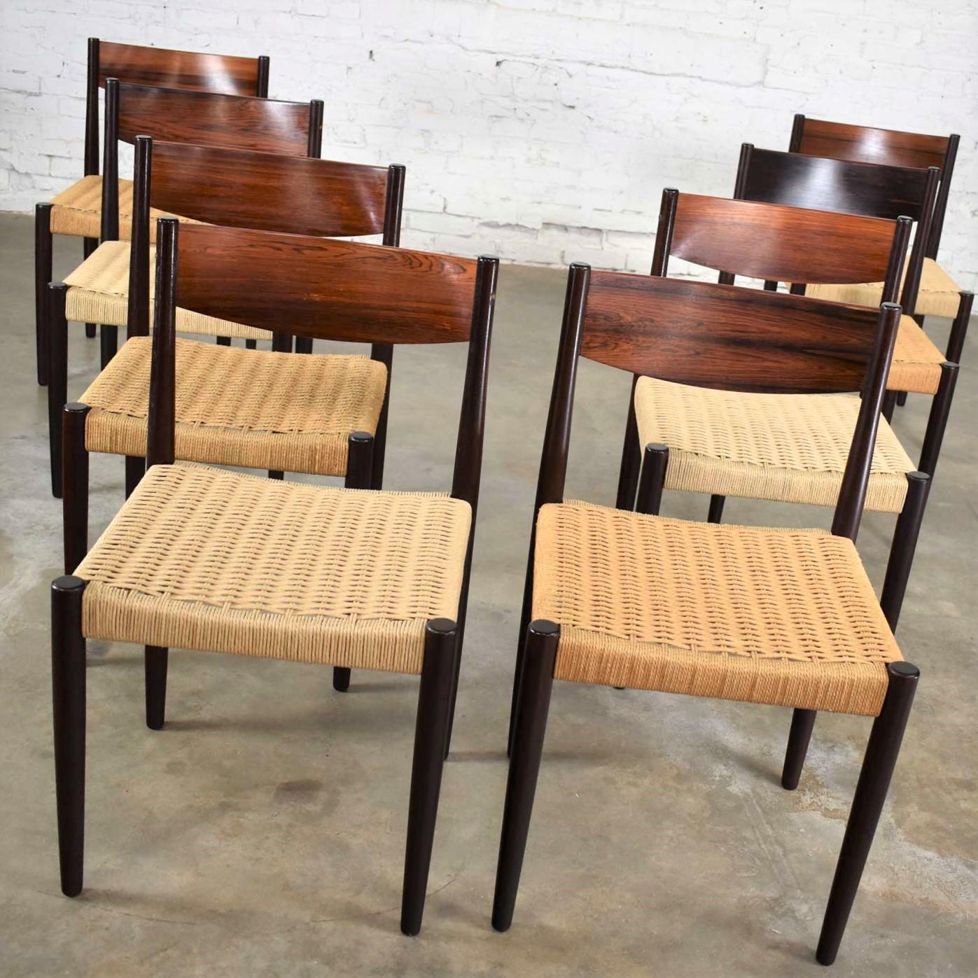 Handsome set of 8 Scandinavian Modern rosewood and paper cord dining chairs designed by Poul Volther and produced by Frem Røjle. They are in fabulous vintage condition. Four of the chairs have new cording and is a bit lighter in color than the old