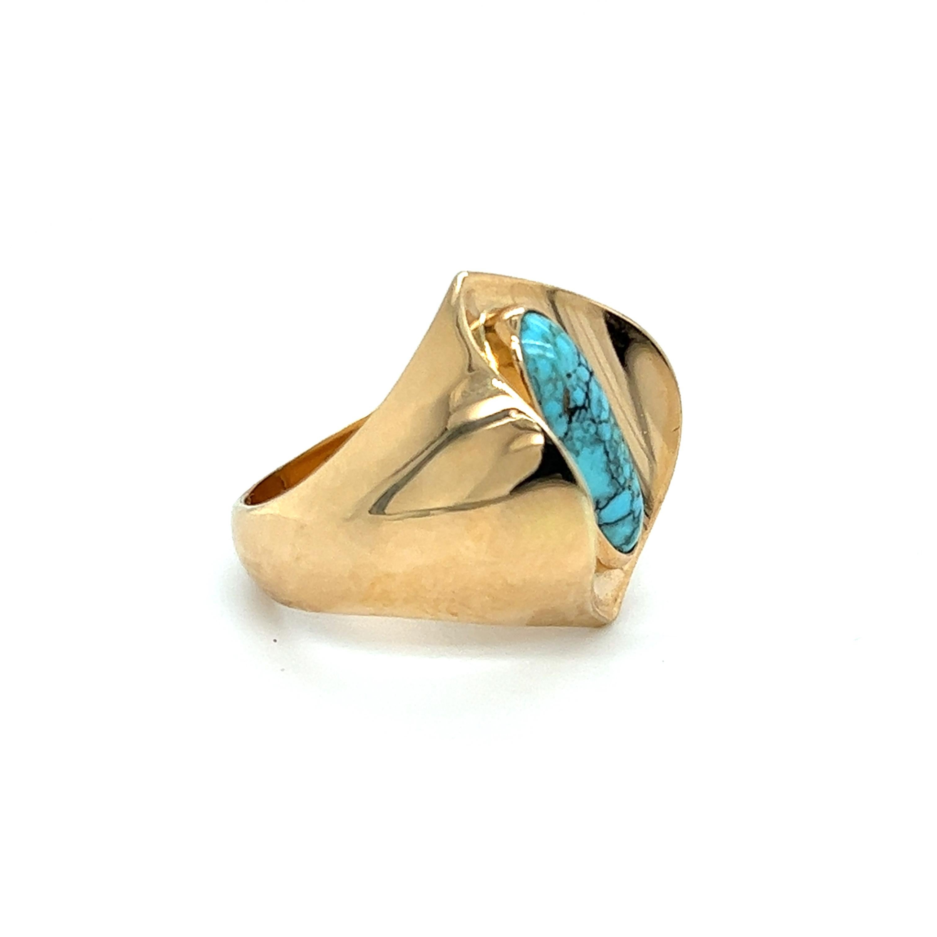 The  Spiderweb Turquoise Ring in 18 karat yellow gold by Danish vintage designer Poul Warmind features a 13.9×5.3 marquise-shaped cabochon spiderweb turquoise in a bezel setting. The band measures 16mm wide at the top and tapers to 4.8mm at the