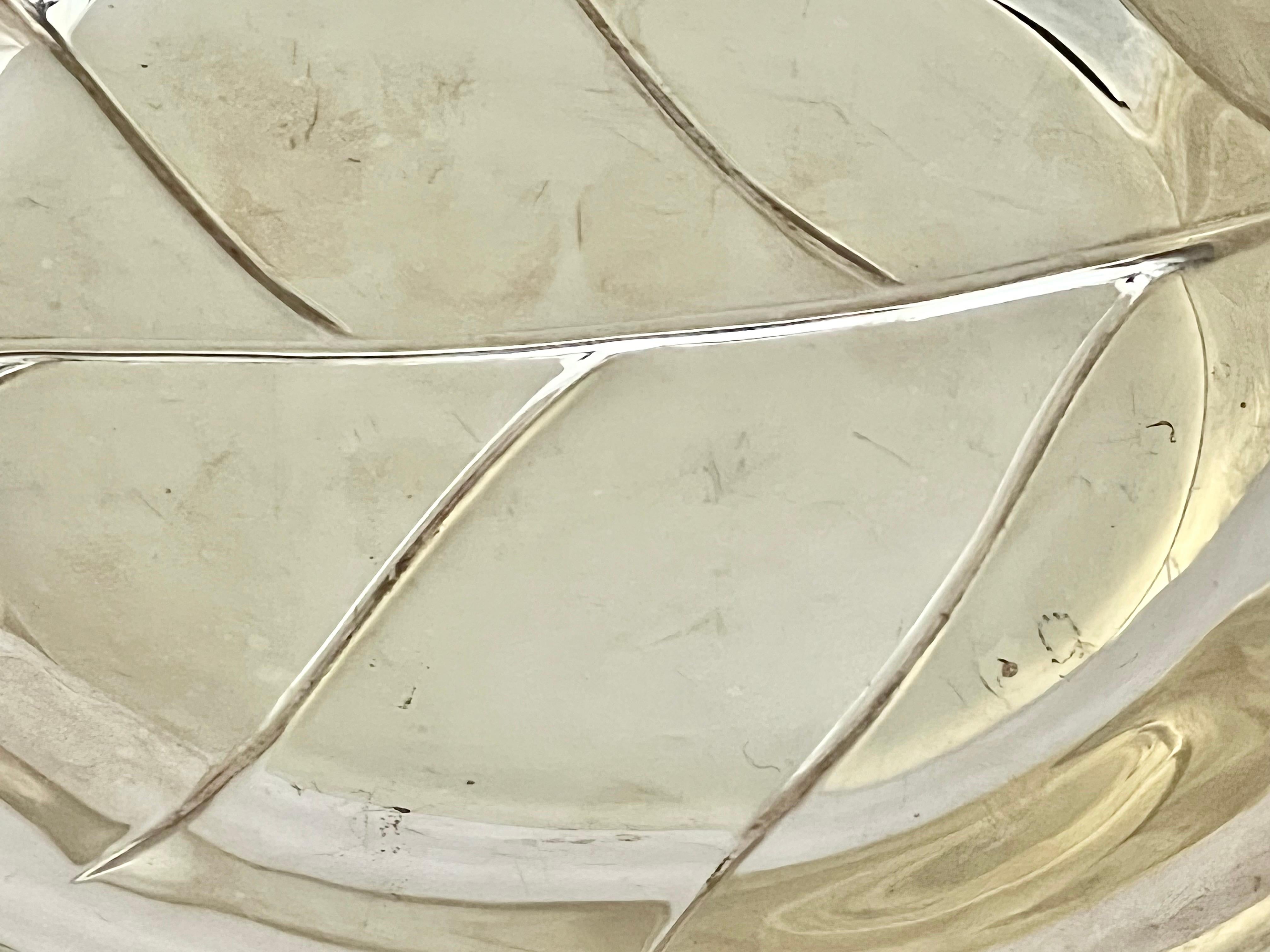 Beautiful silver plate dish depicting a lemon leaf. The leaf is nicely detailed and has a faded but not legible hallmark. This would make a lovely soap dish for your powder room. Hallmarked 348 Silver Co.