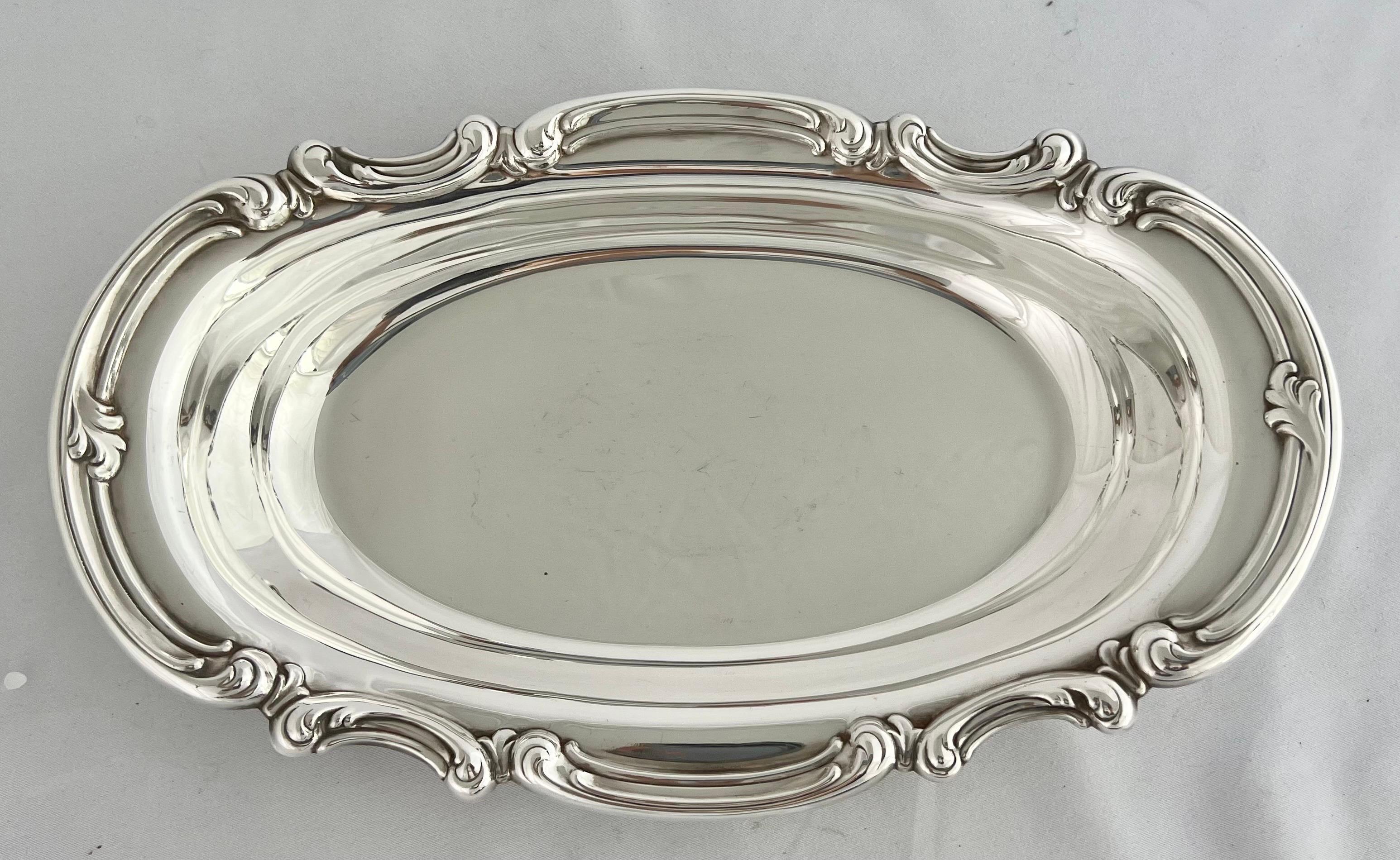 American Gorham silver plated serving dish with scrolled detail around the edge of the piece. It would be great to serve food but you can also use it for hand towels in you powder room. The dish is hallmarked Gorham with an anchor.