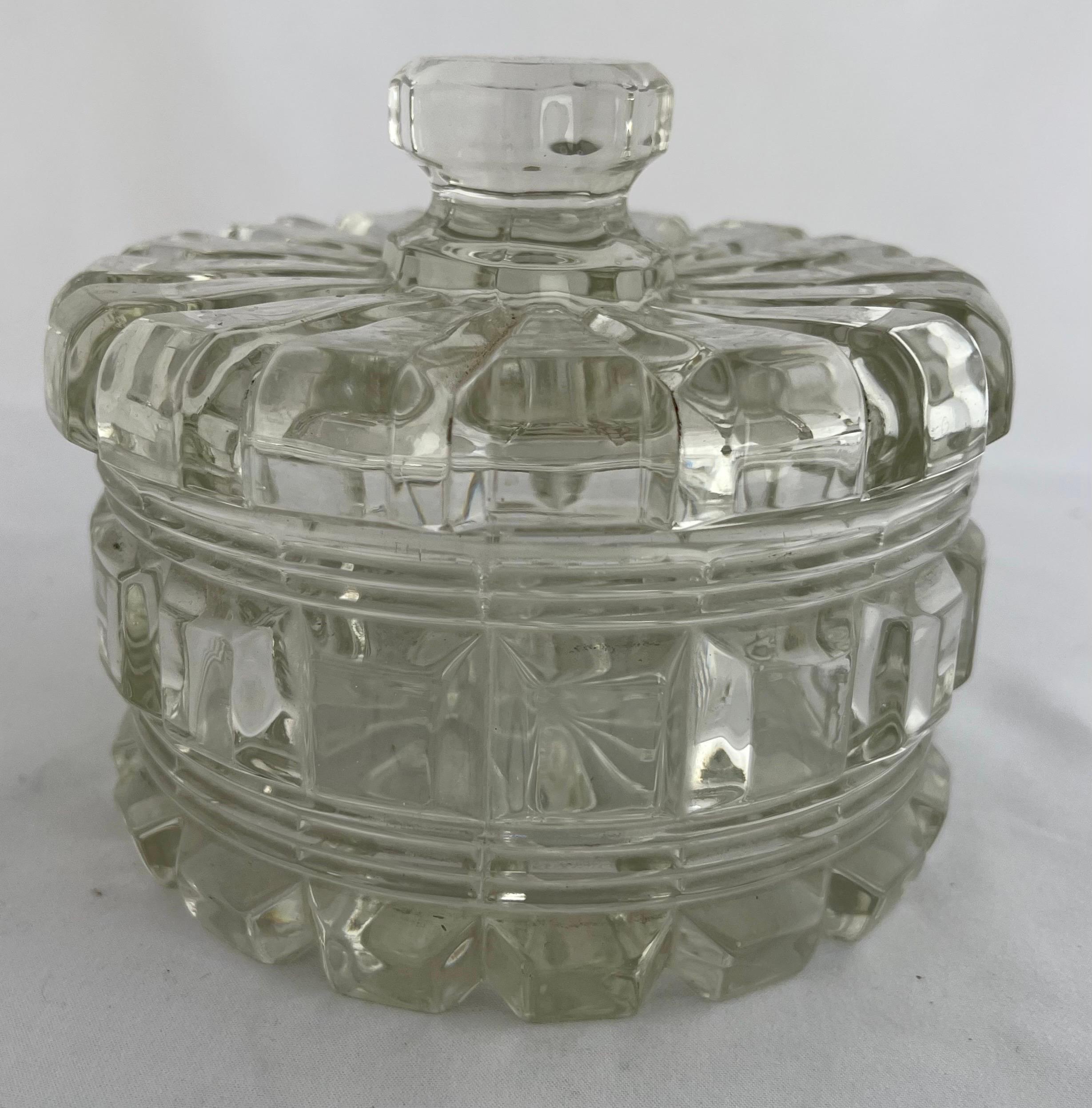Large round cut crystal vanity lidded container. It is perfect for cotton & q-tips. I am sure you have a few treasures that need a home. No makers mark could be found.