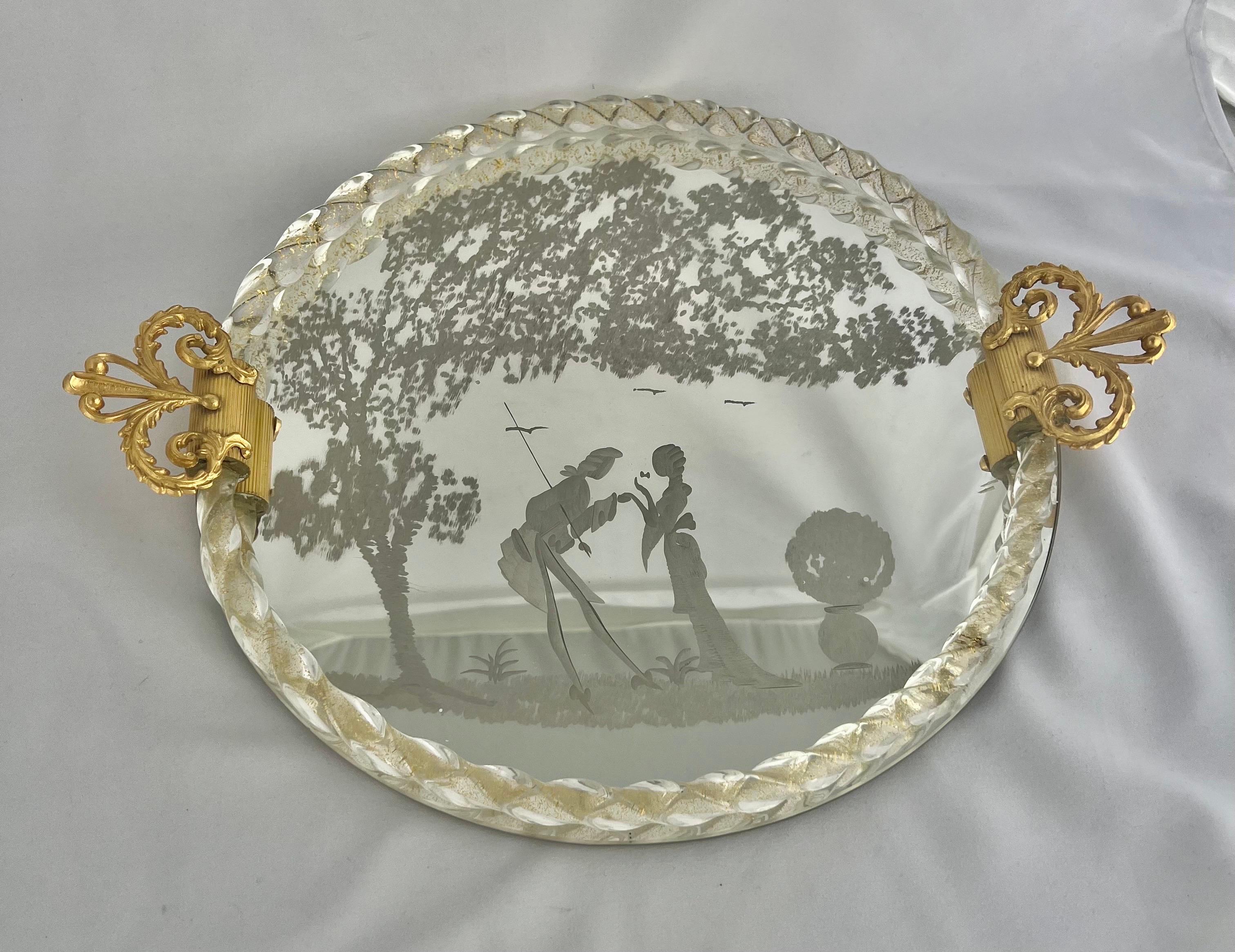 Romantic Murano glass tray. This tray features a reverse etched dancing couple in a lakeside garden under a tree. It also has a twisted rope glass border with two brass handles. The back is finished in wood with laminated veneer.