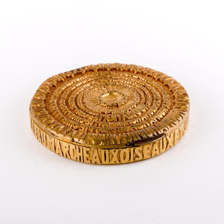 His iconic compact in gilded bronze represents a casting of Jacques Prévert poem 